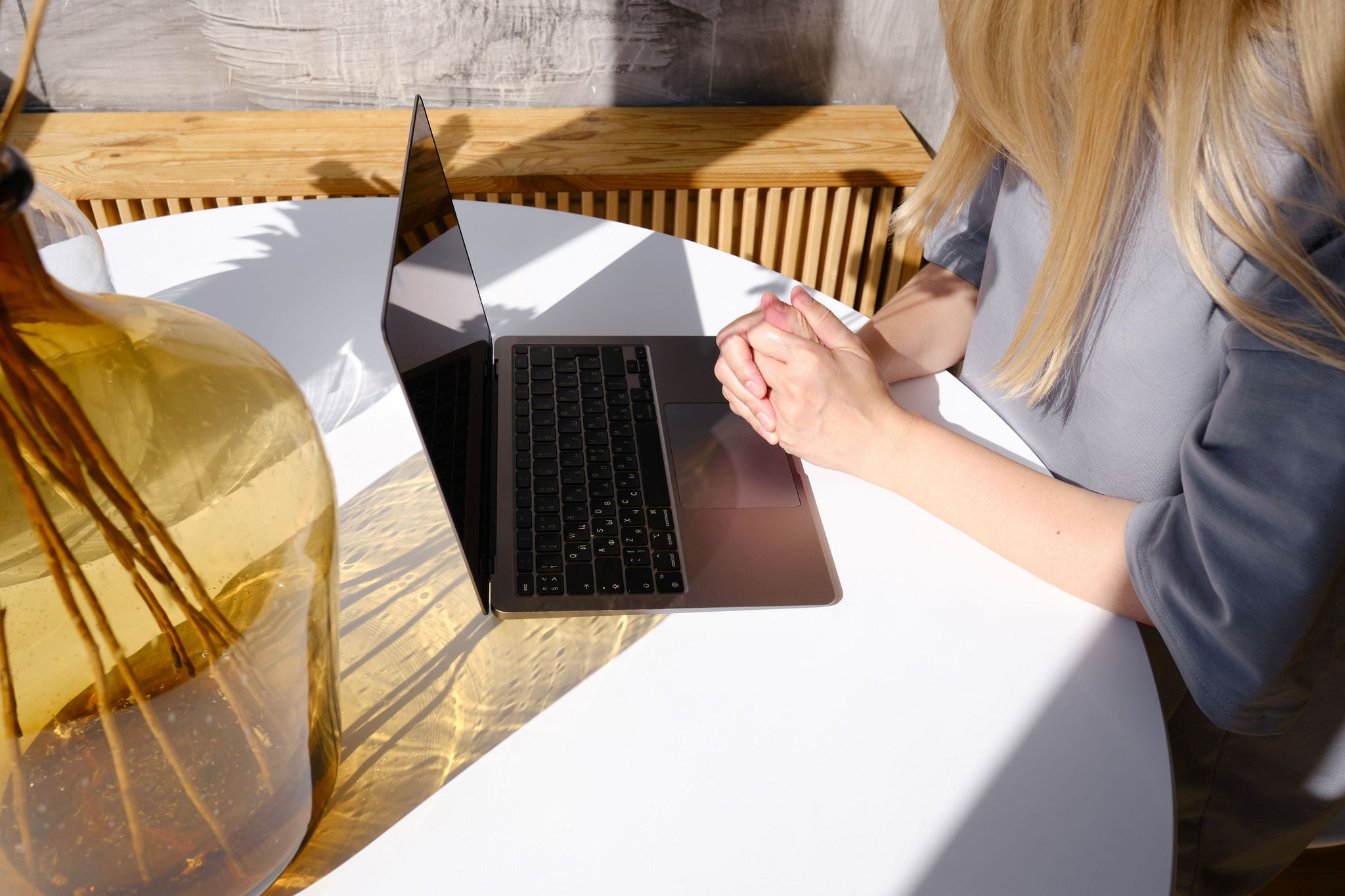 woman sitting on table with laptop