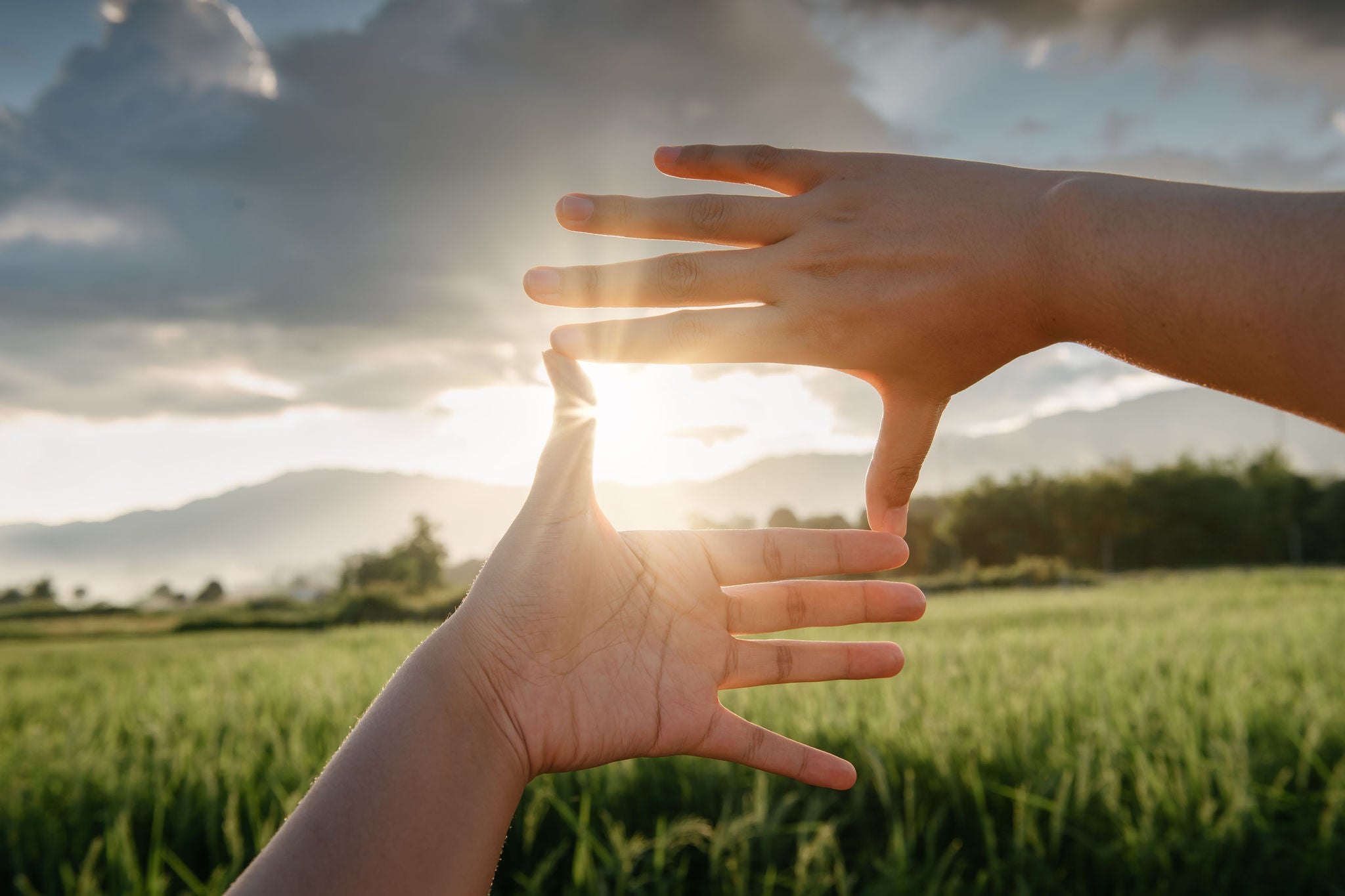 Hands focusing sunlight