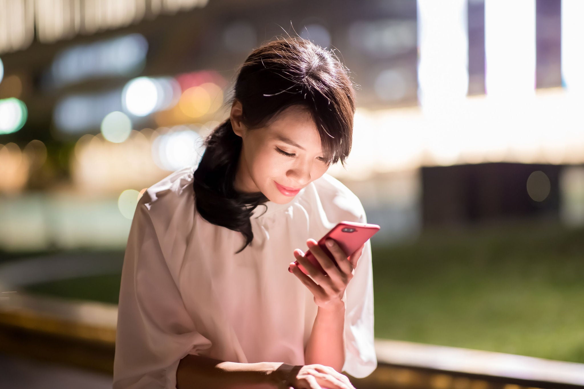 A woman looking into the phone