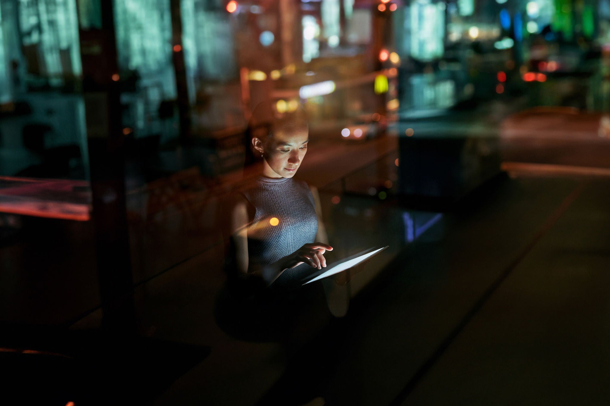 Woman at night on her tablet