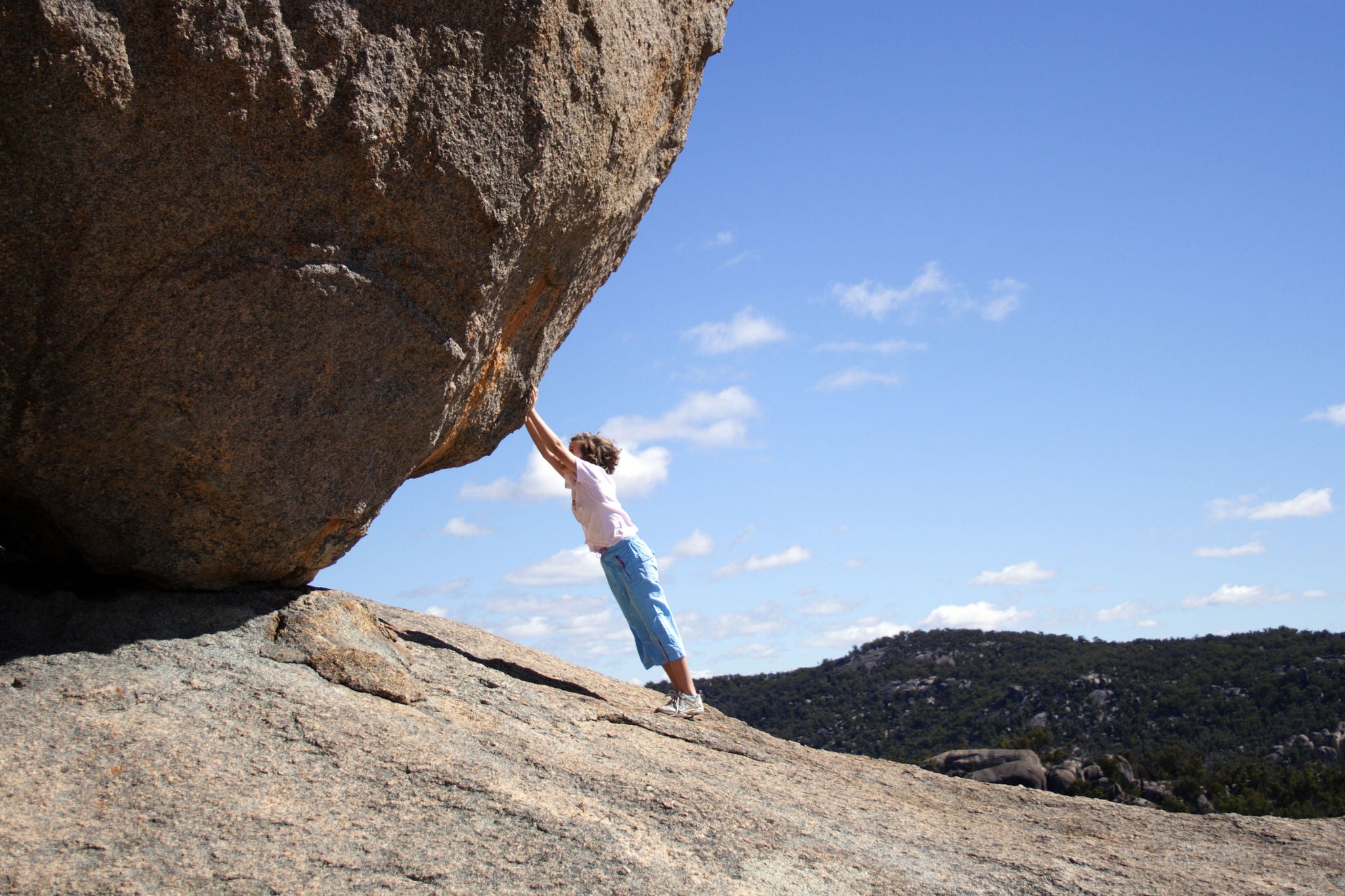 ey little girl pushing boulder