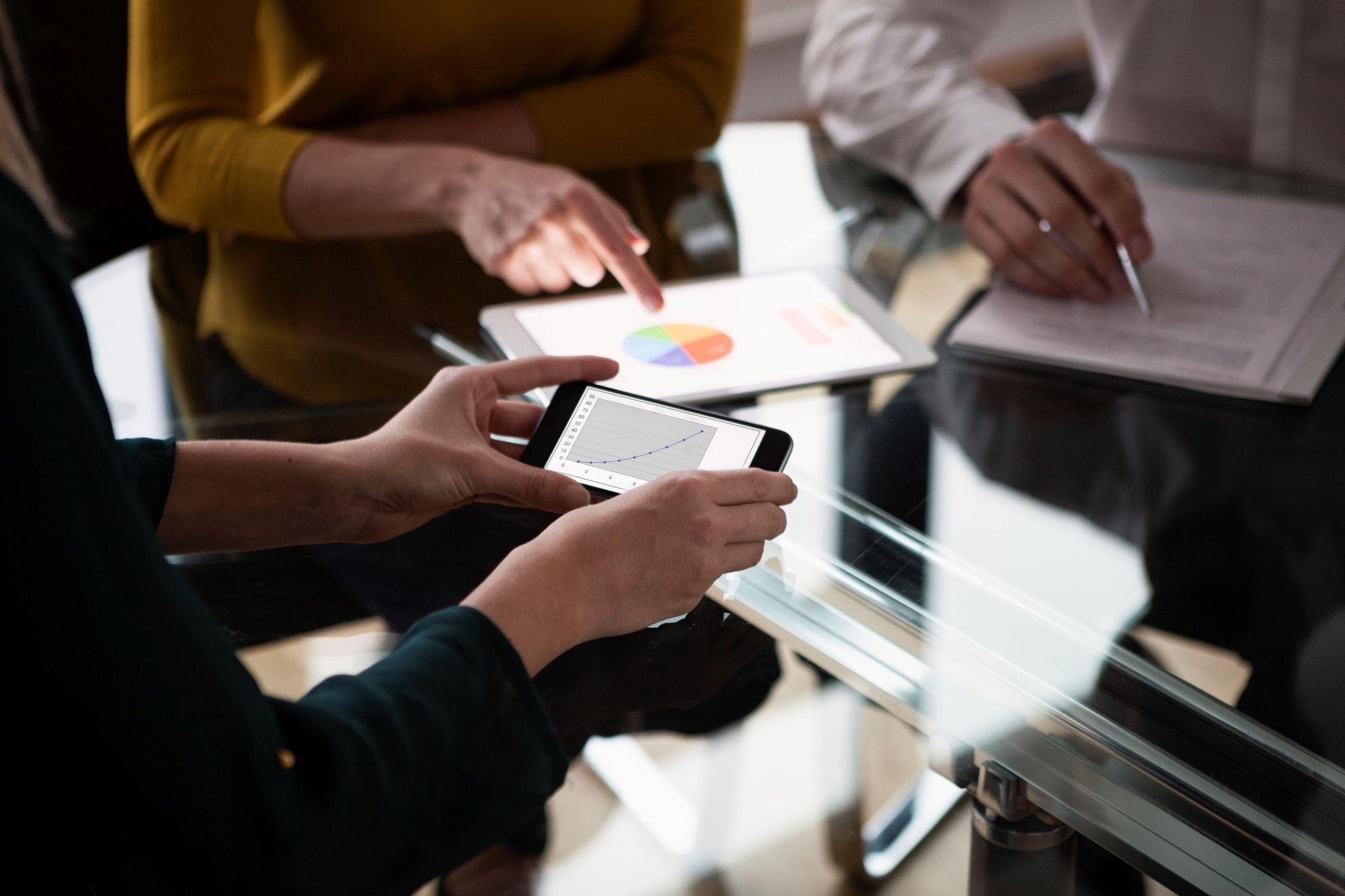 People discussing with the tablet on the table