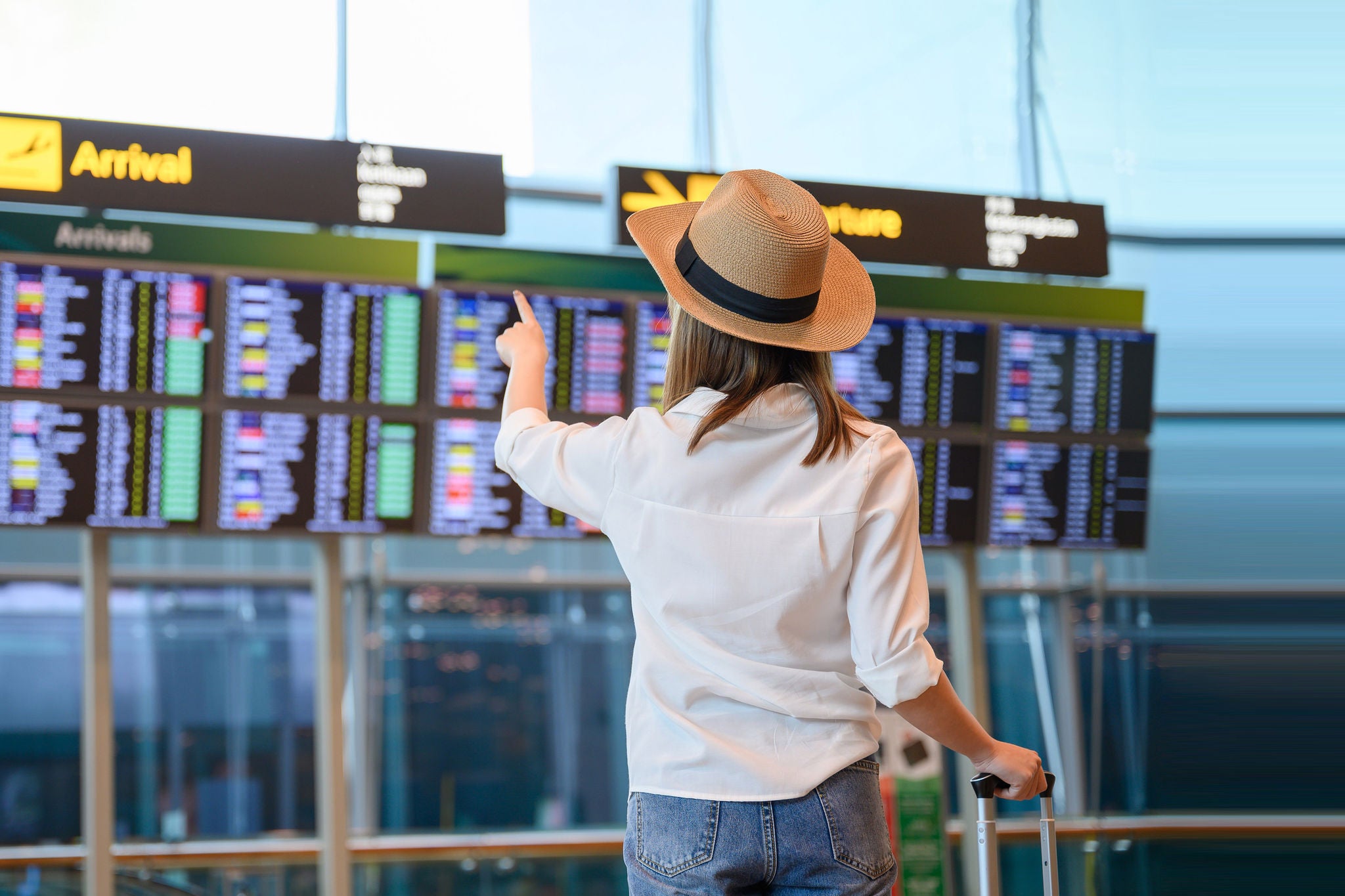 Girl checking her flight in the digital board