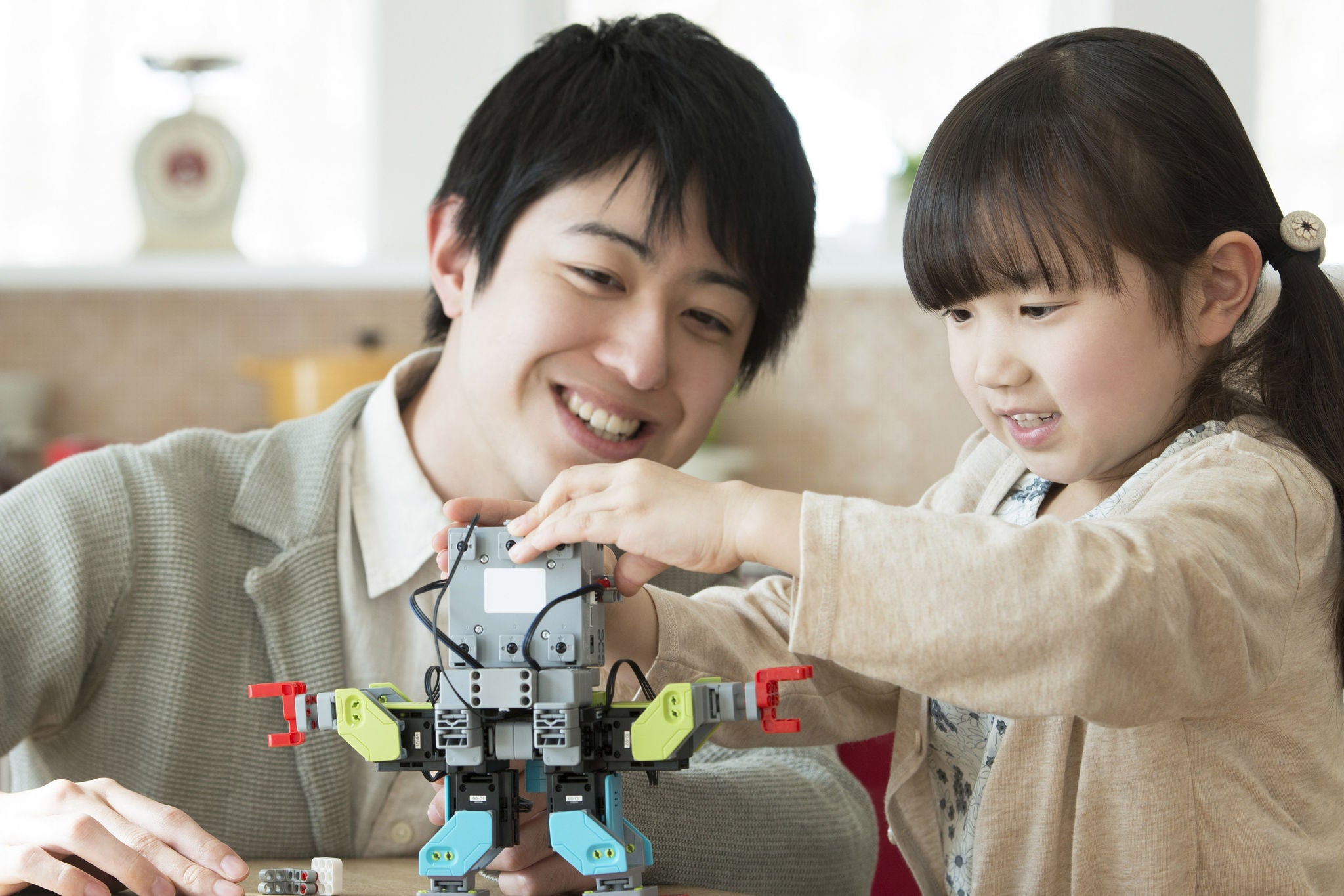 Parent and child assembling a robot