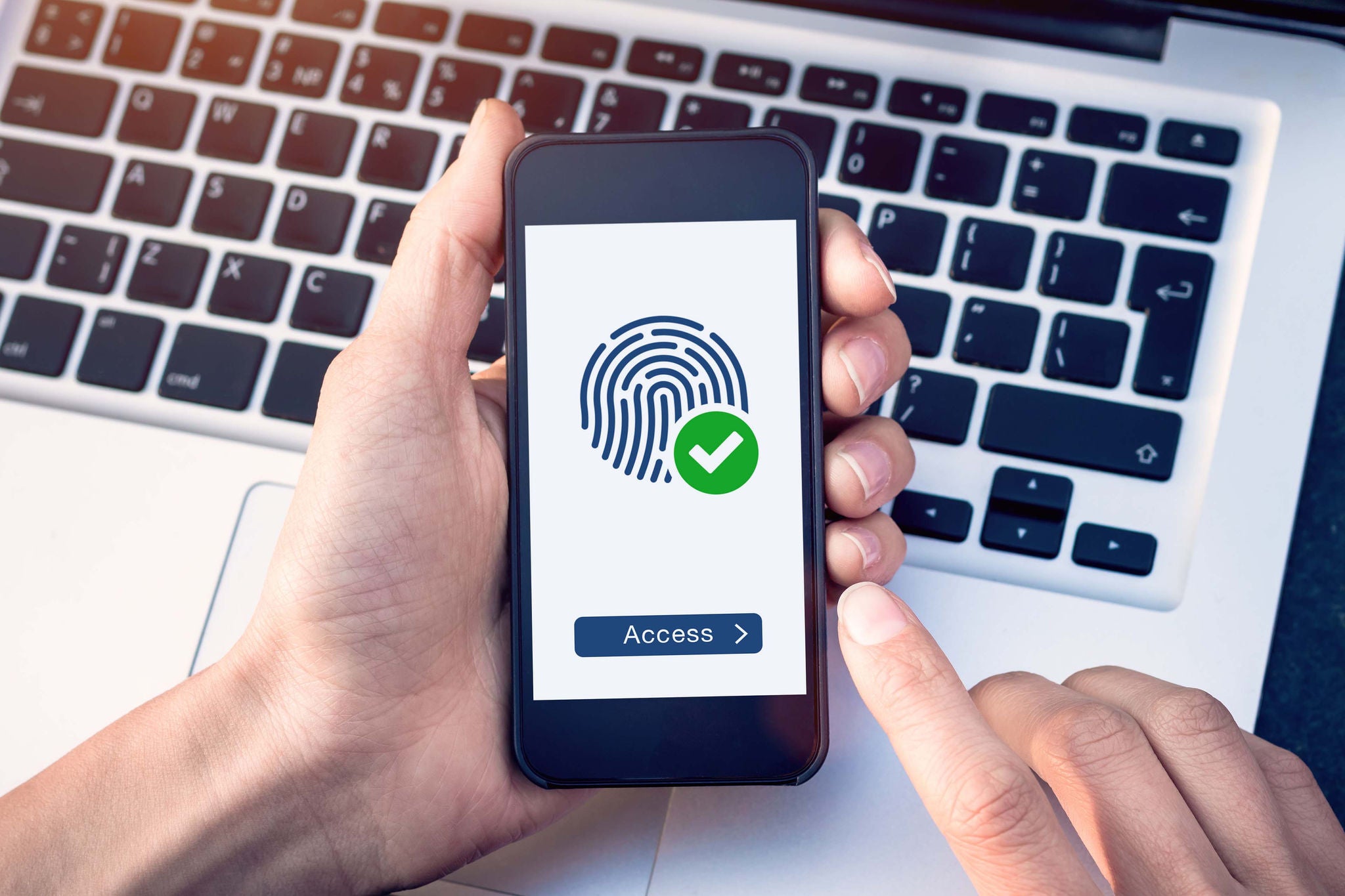 Secure access granted by valid fingerprint scan, person holding smartphone connected with wifi