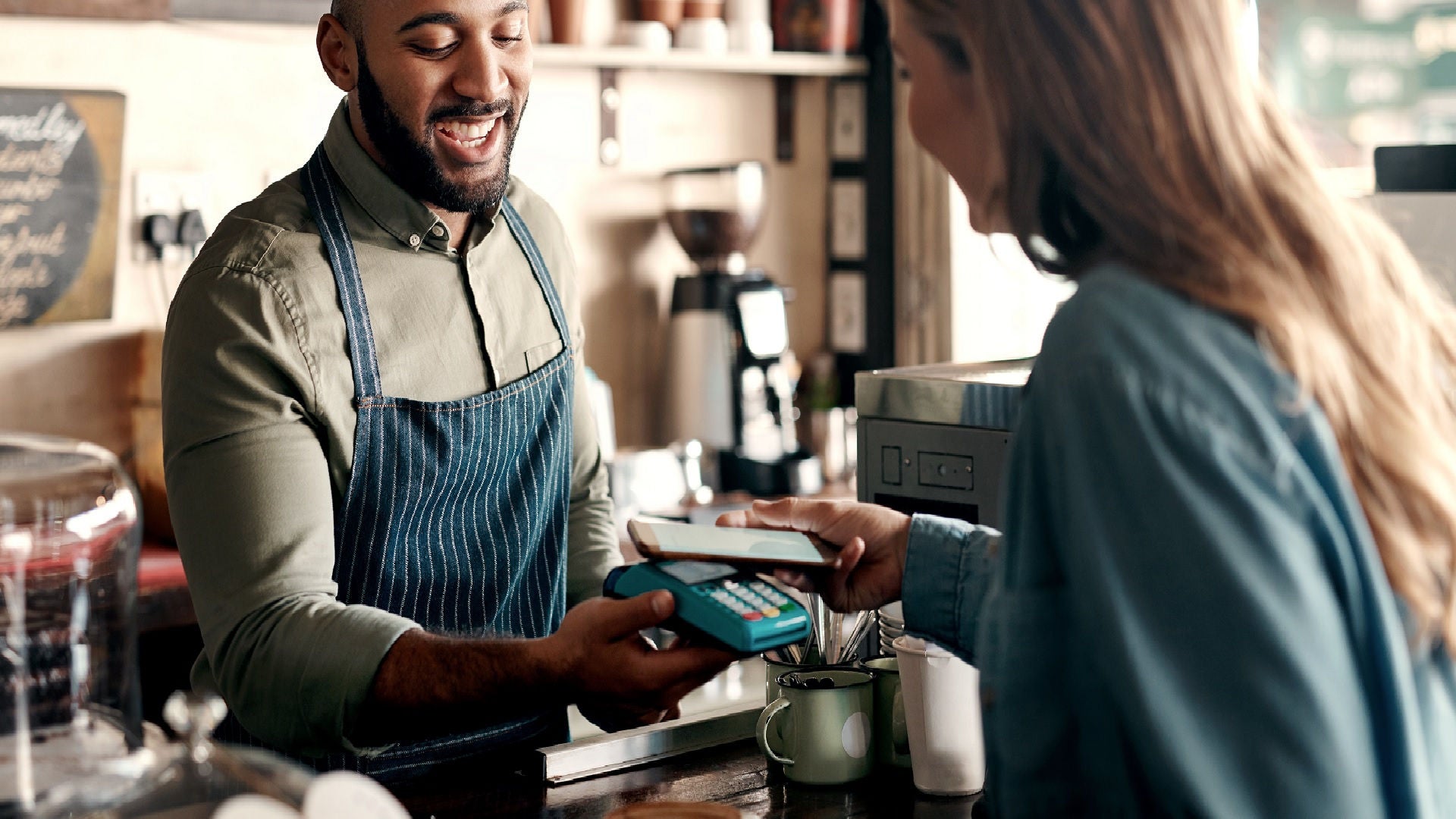 Lady paying digitally for cappuccino