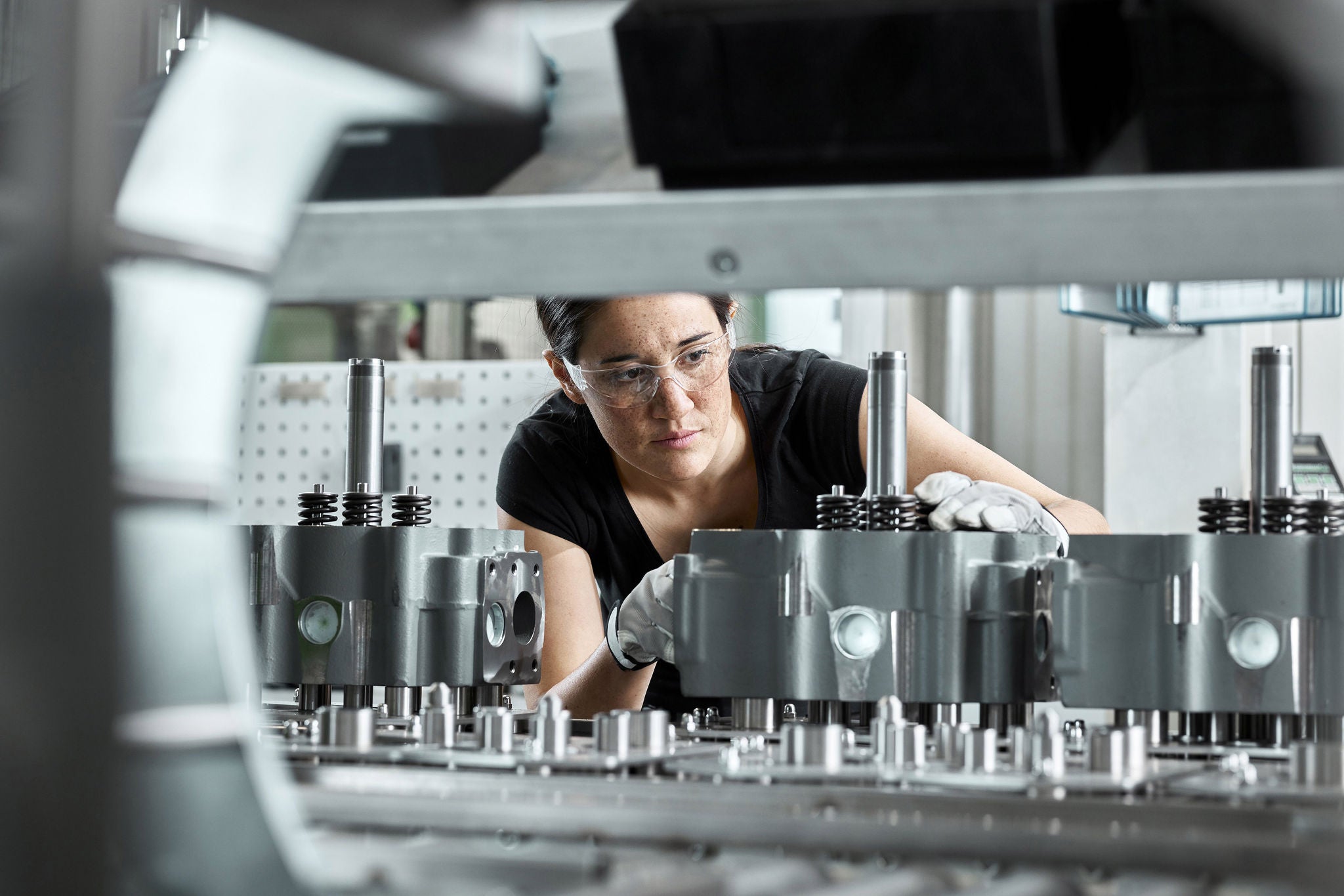 Young woman checking production line on a conveyor belt