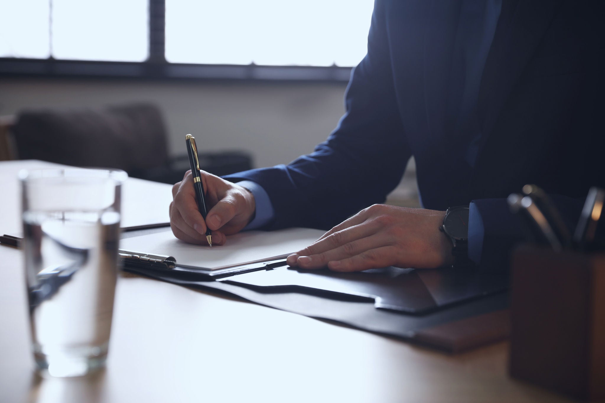 Male lawyer working at table in office, closeup