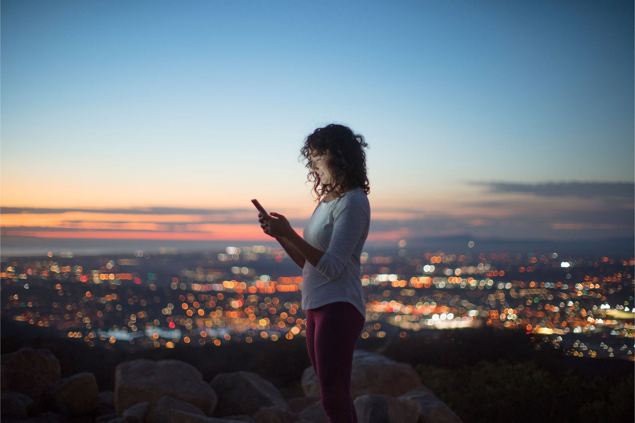 women viewing phone working with nature