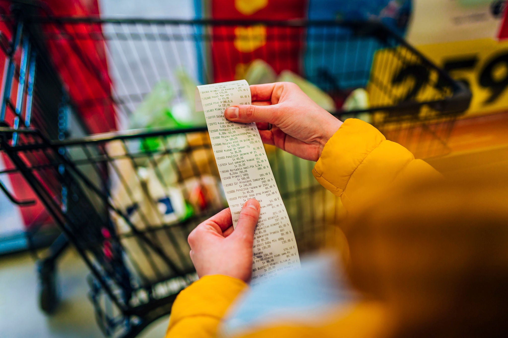 Woman checking the bill when paying at a supermarket