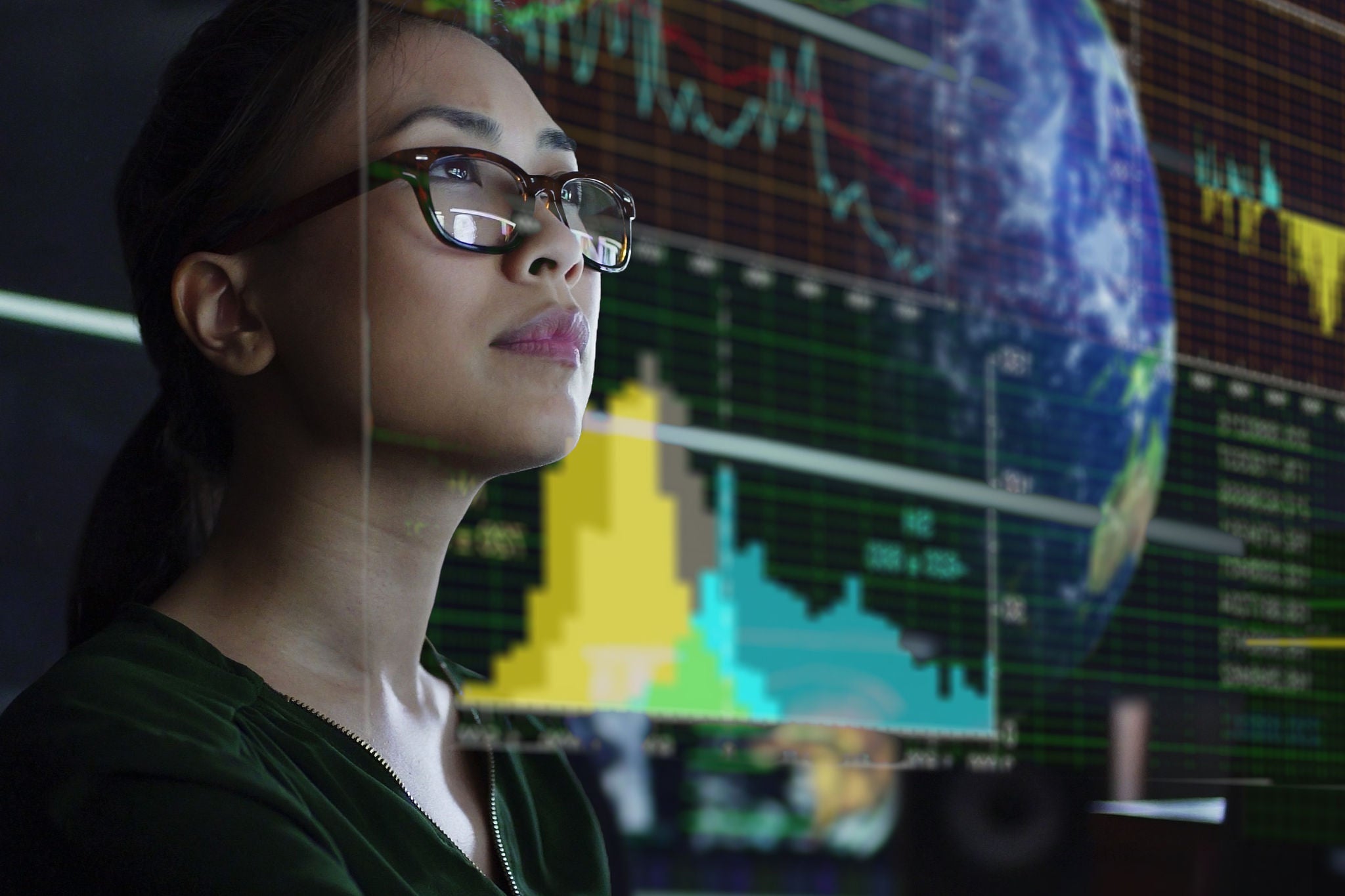 Woman looking at screen showing global and environmental-data