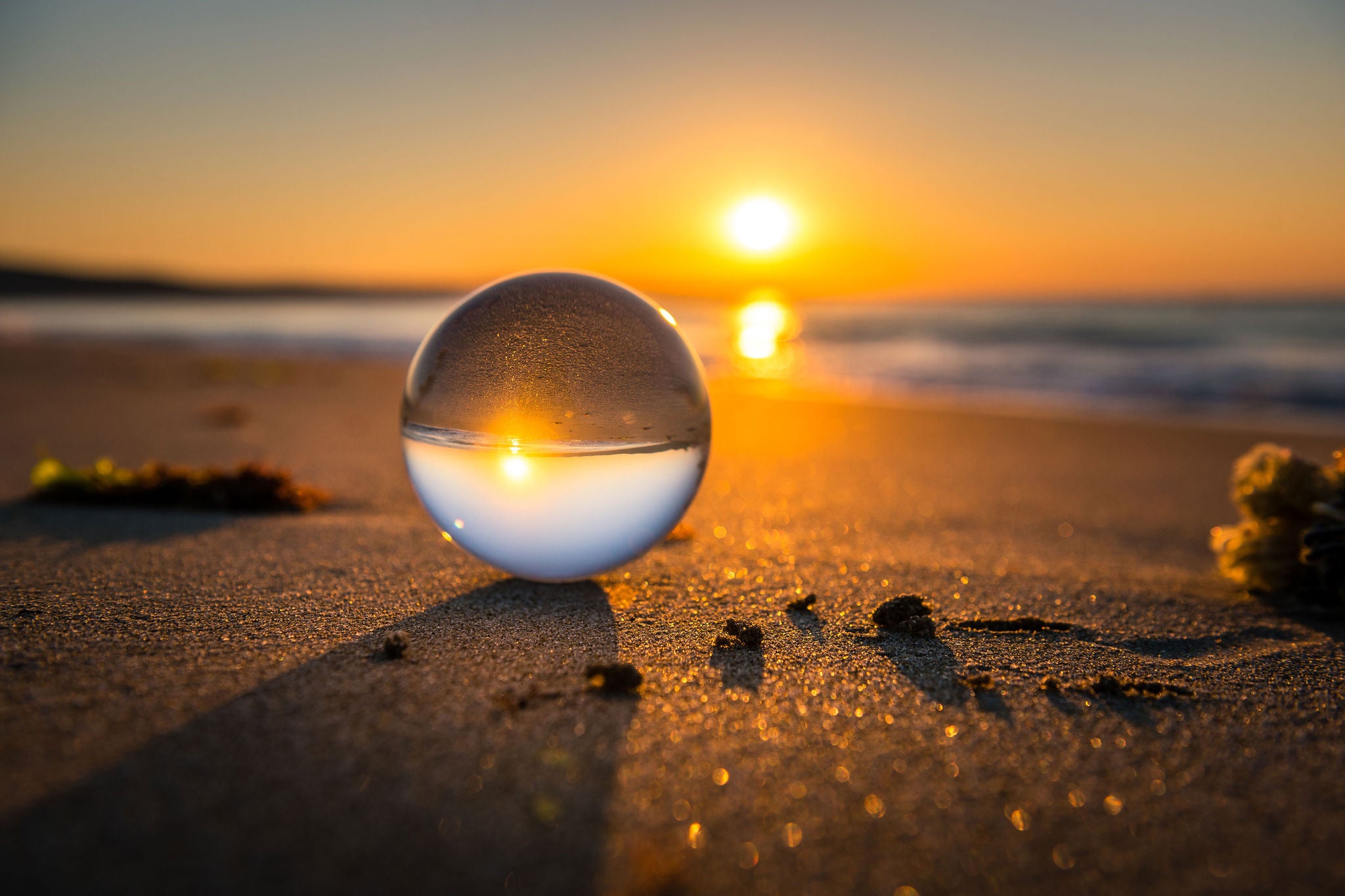 Crystal ball on a beach during sunset