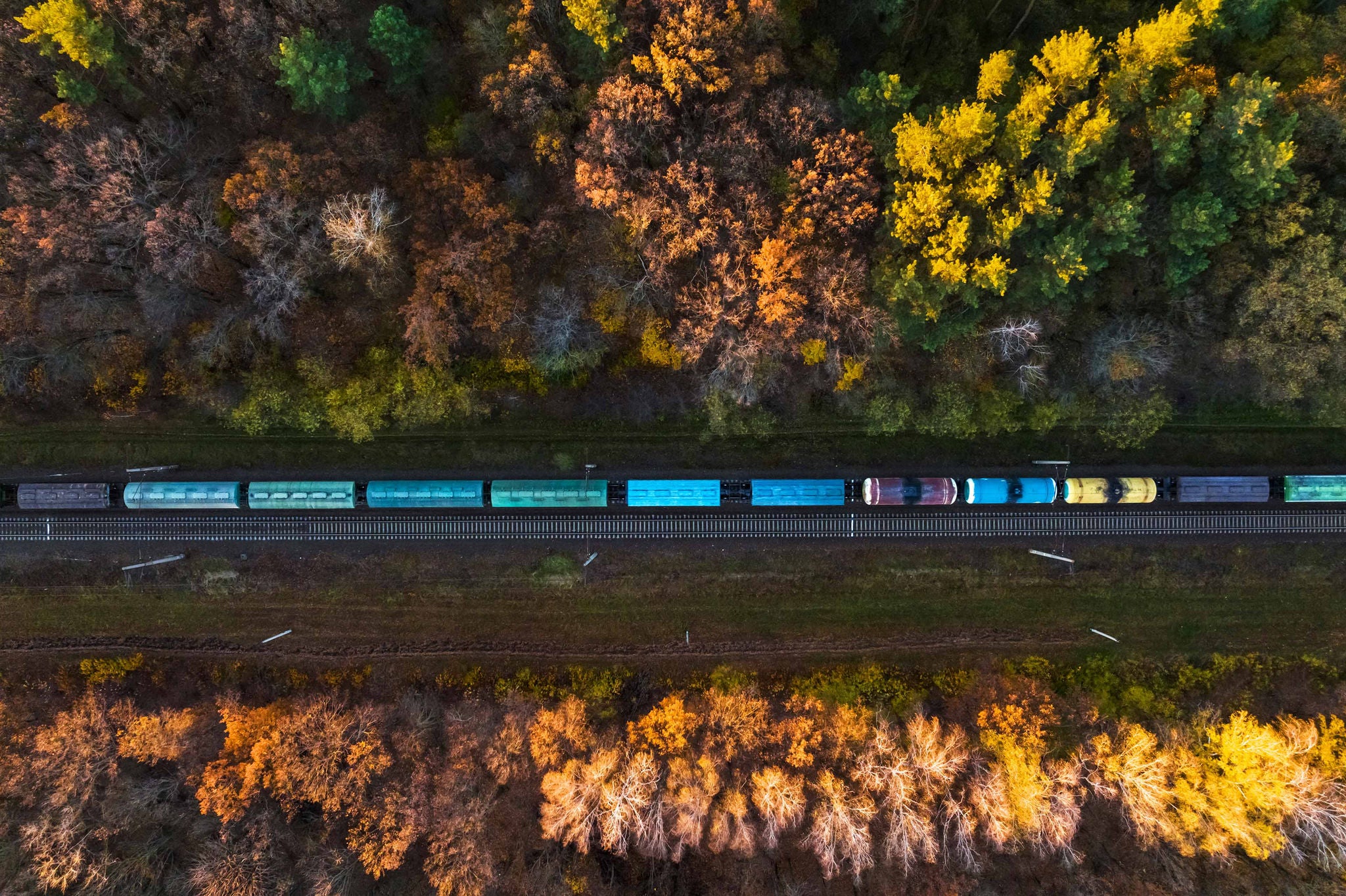 Aerial view of a freight train at dawn in autumn