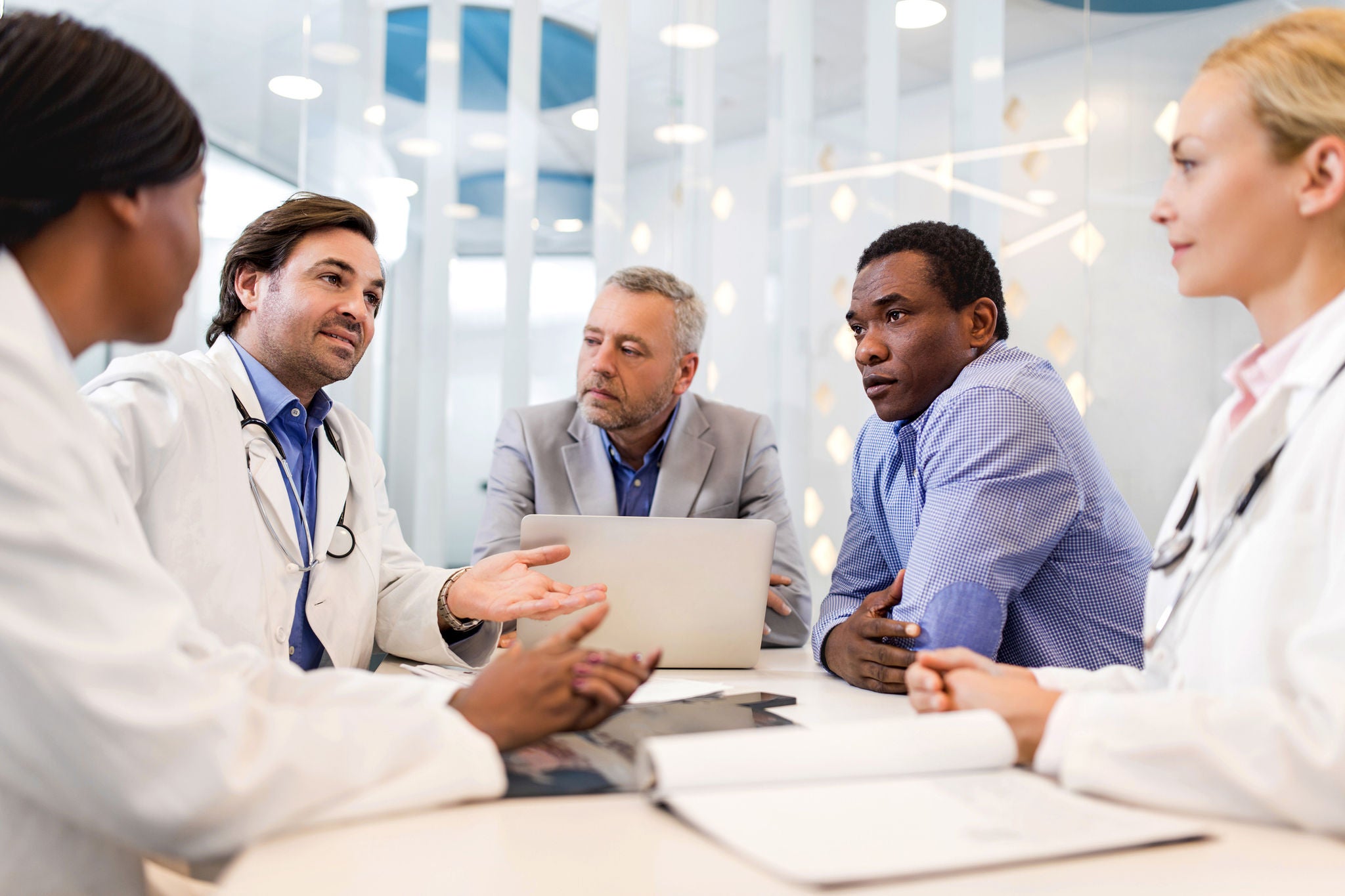 Doctors and business people cooperating on a business meeting.