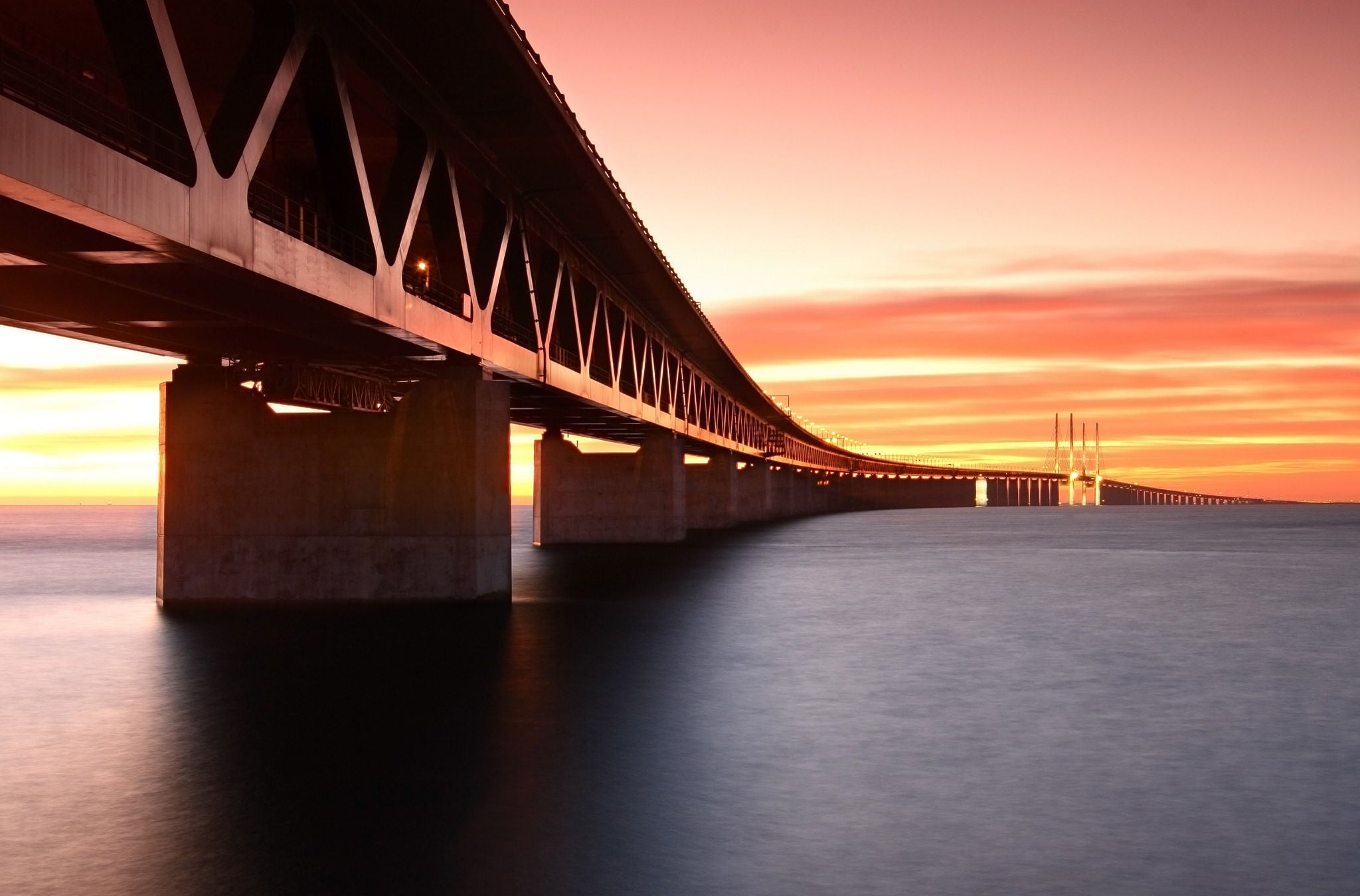 A bridge over water at sunset