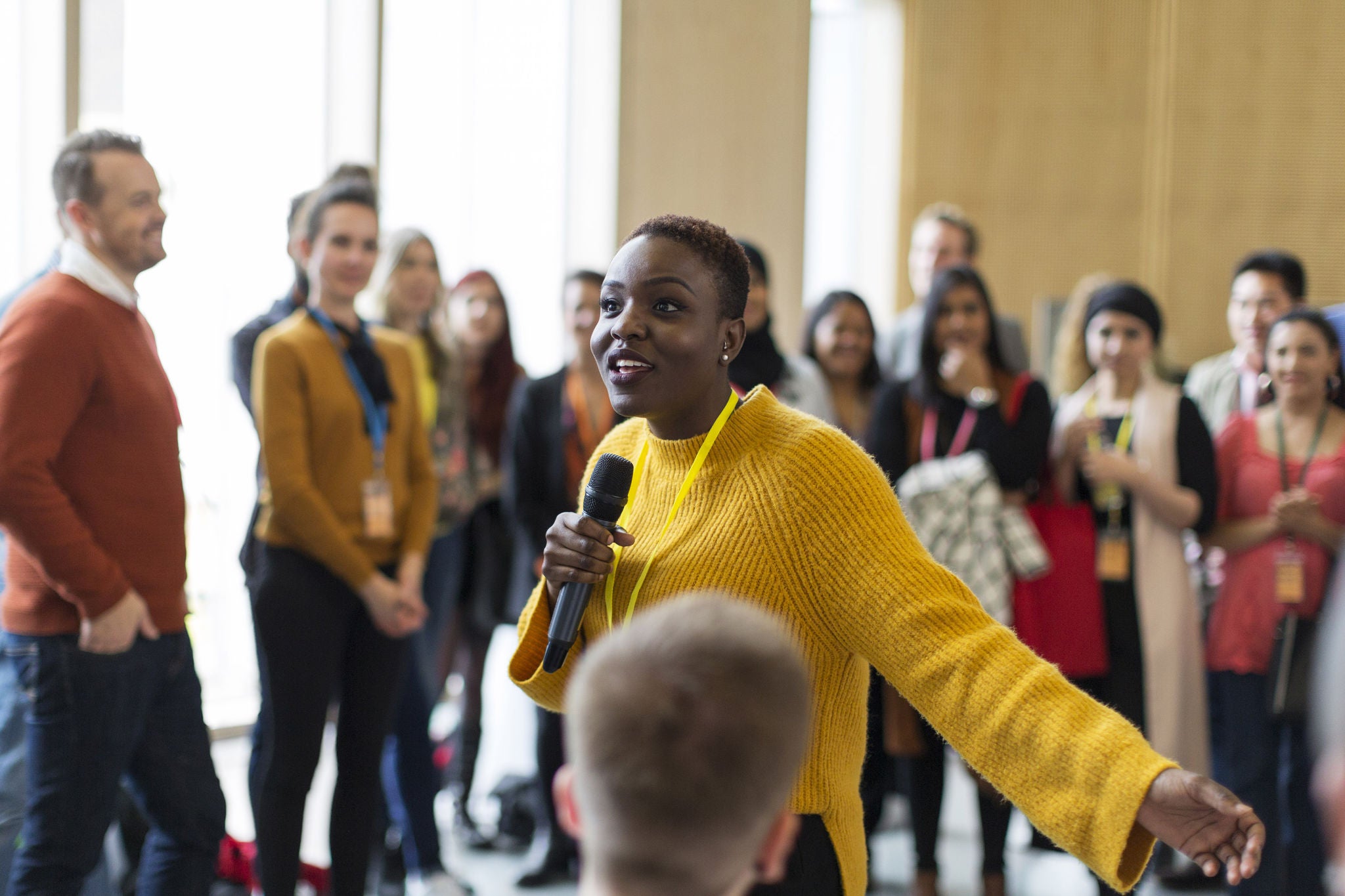 A woman talking in front of a crowd