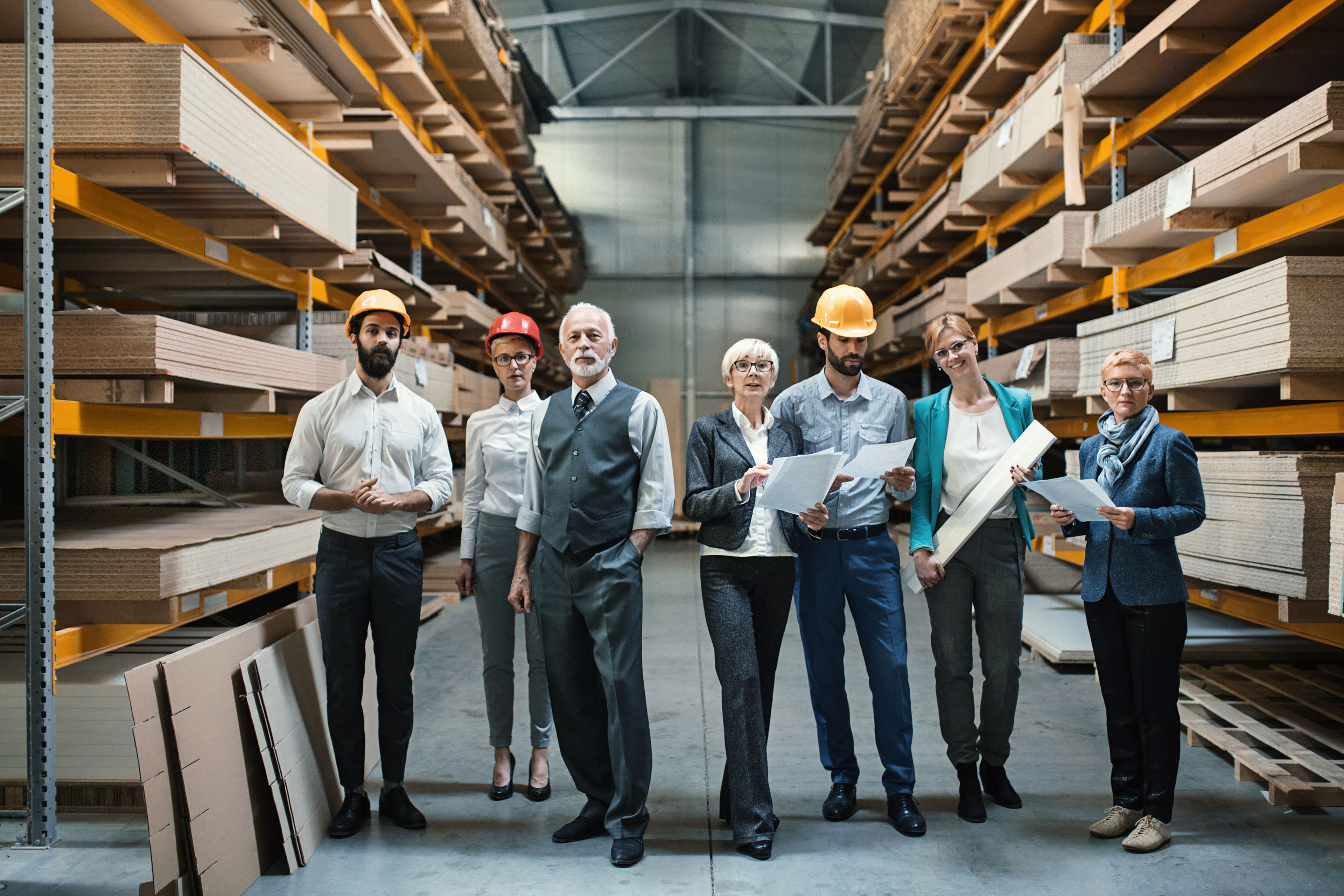 Closeup front view of mixed age people of industrial design department at a factory. 