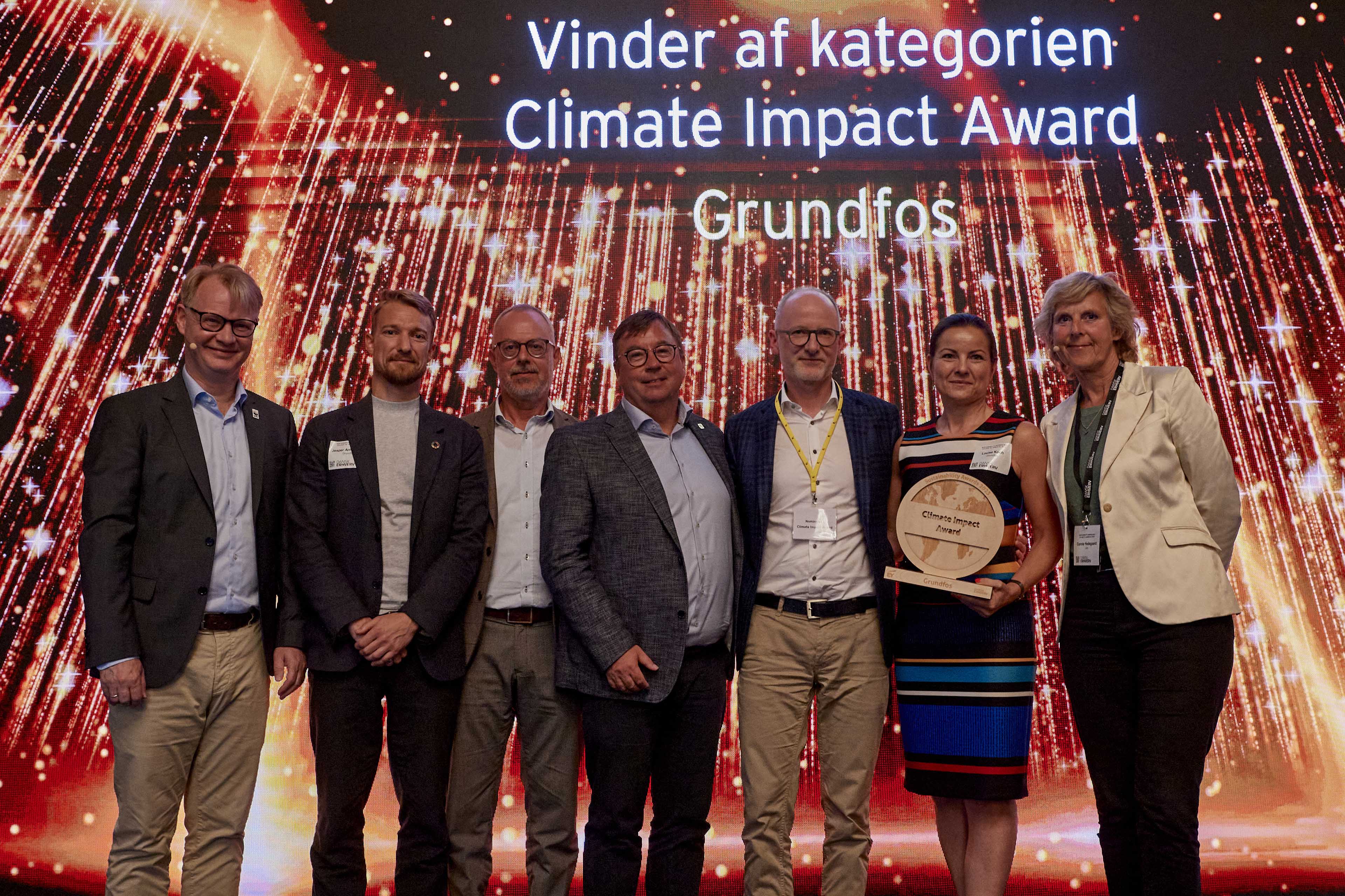 group of people giving a pose with award in sustainability awards 2023