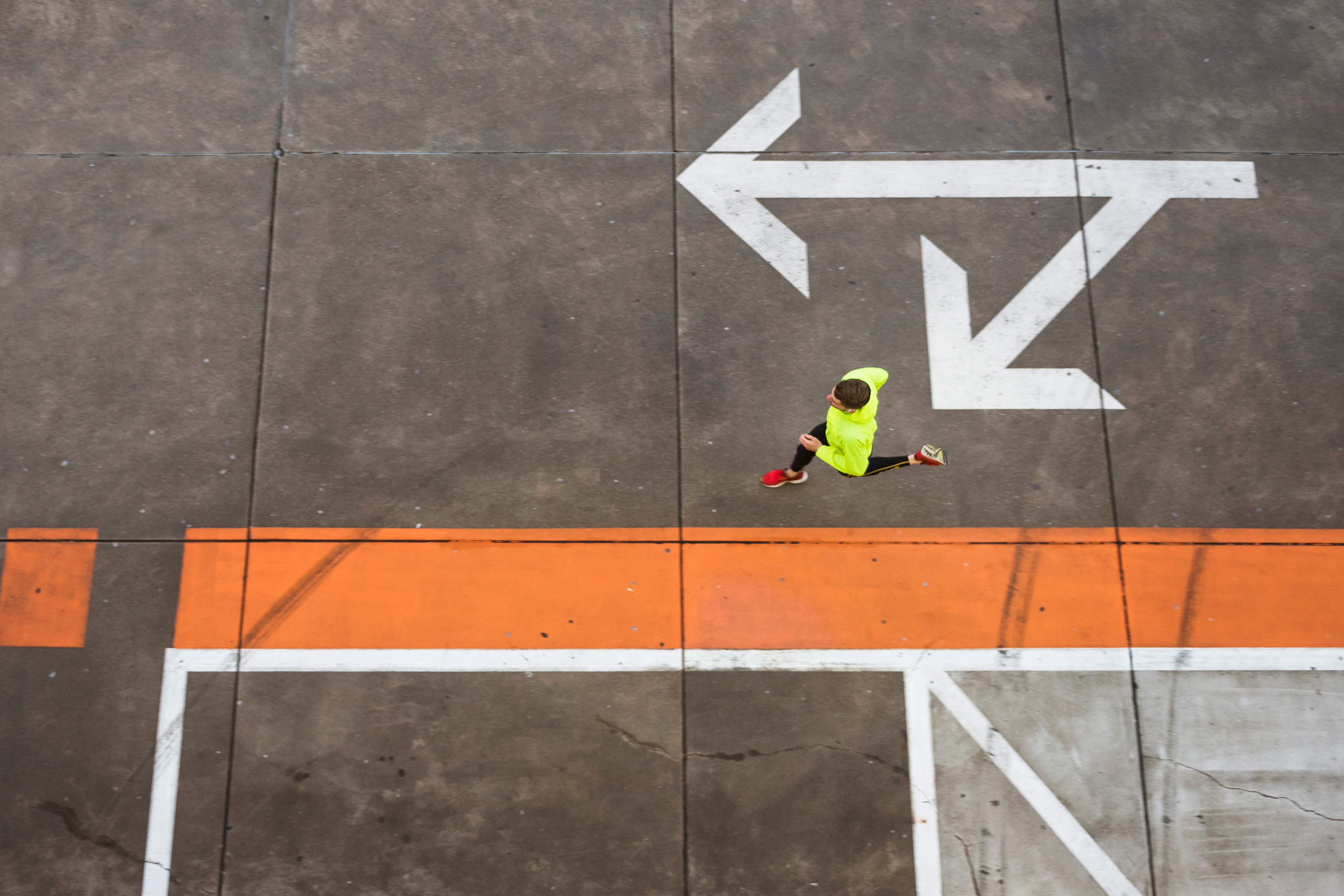 Young man running on parking level