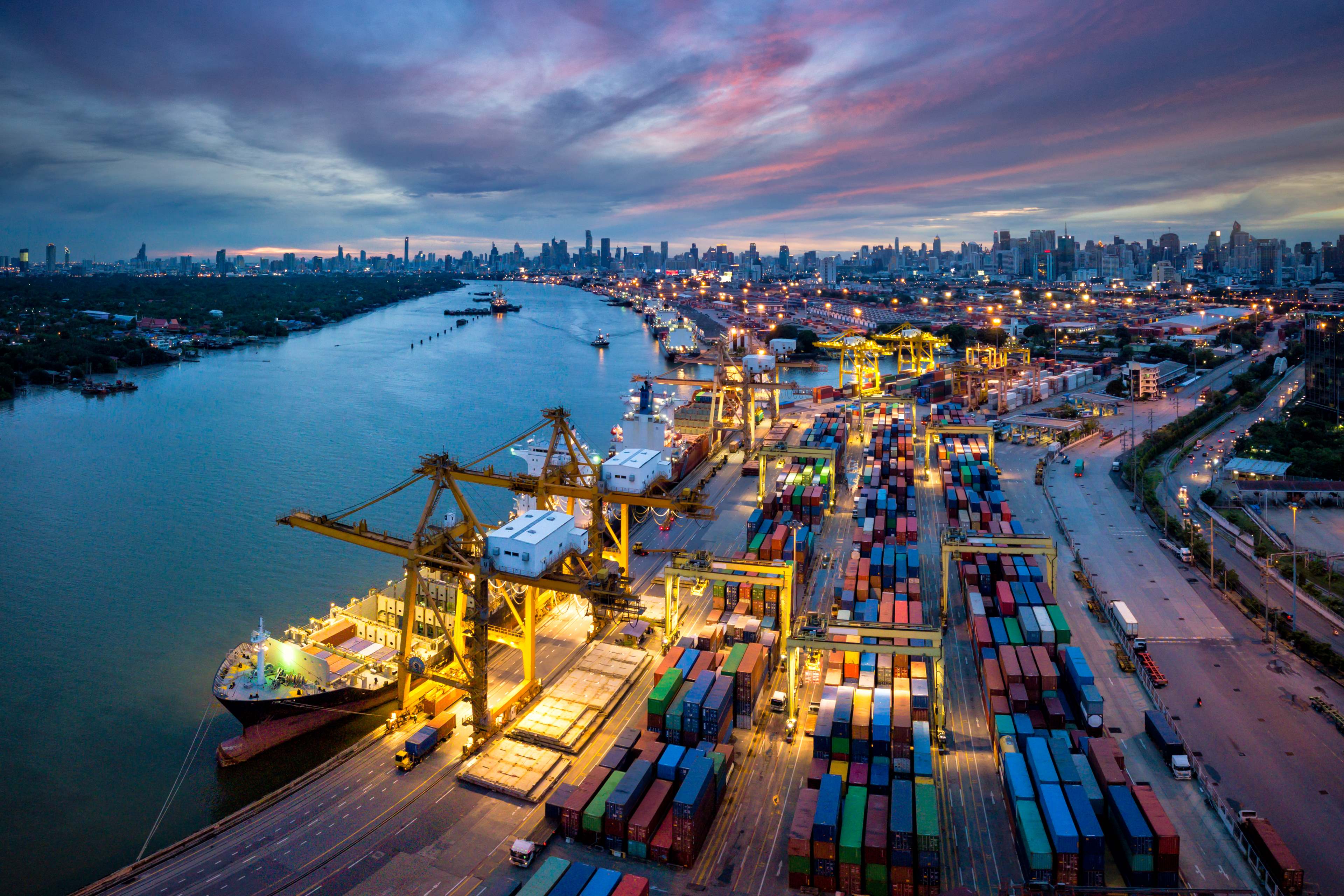 Aerial view of international port with Crane loading containers in import export business logistics 