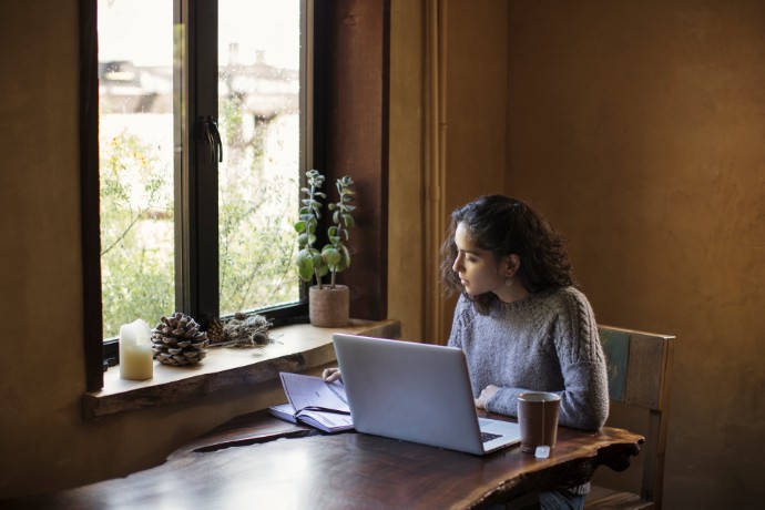 Woman sitting at a table with a laptop