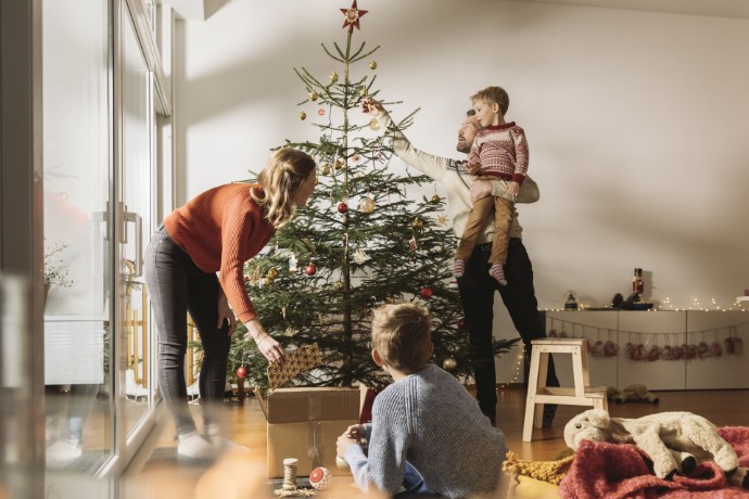 Family decorating christmas tree