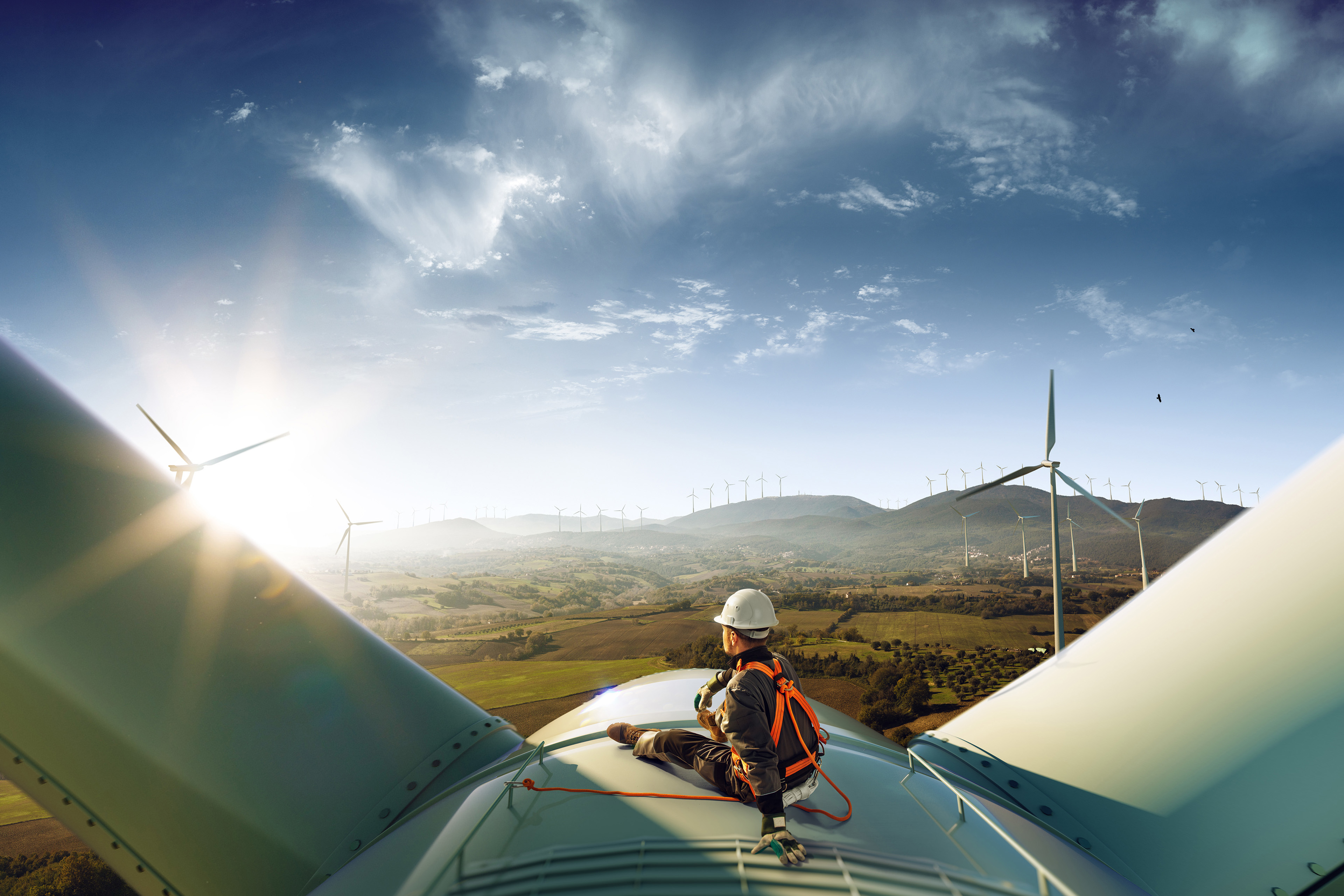 Man sitting on a wind fan