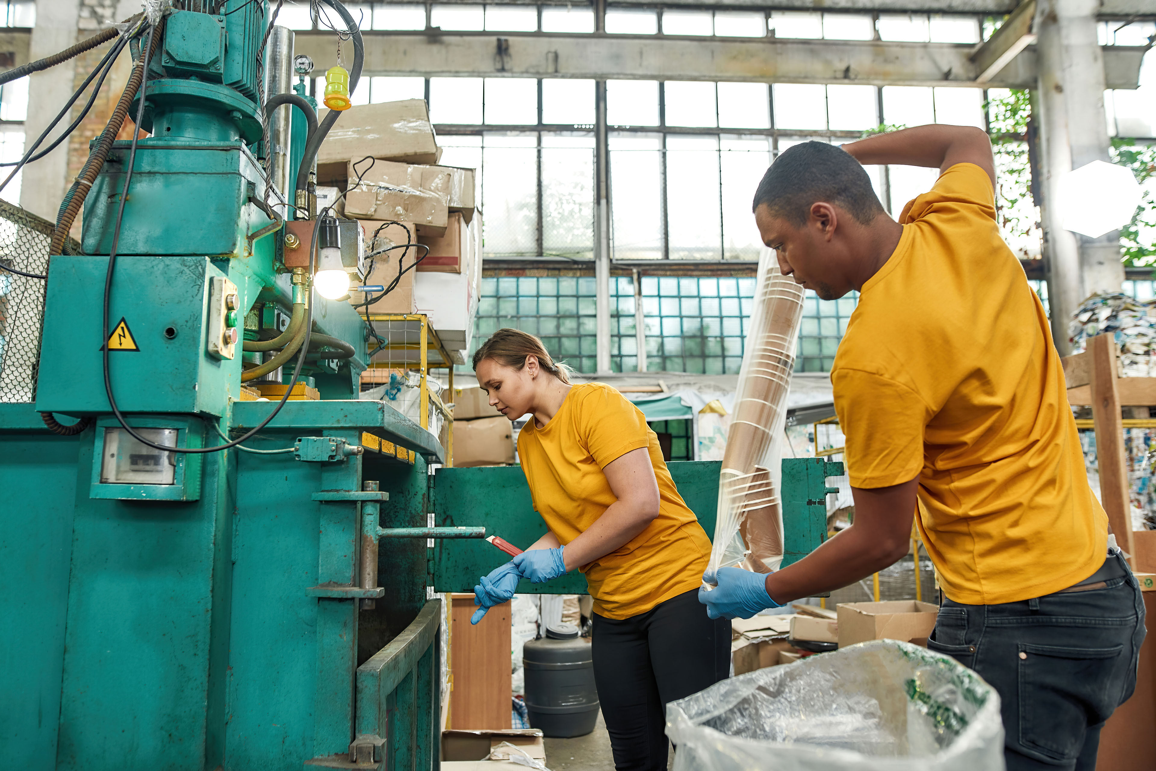 Two persons cleaning and checking the machines