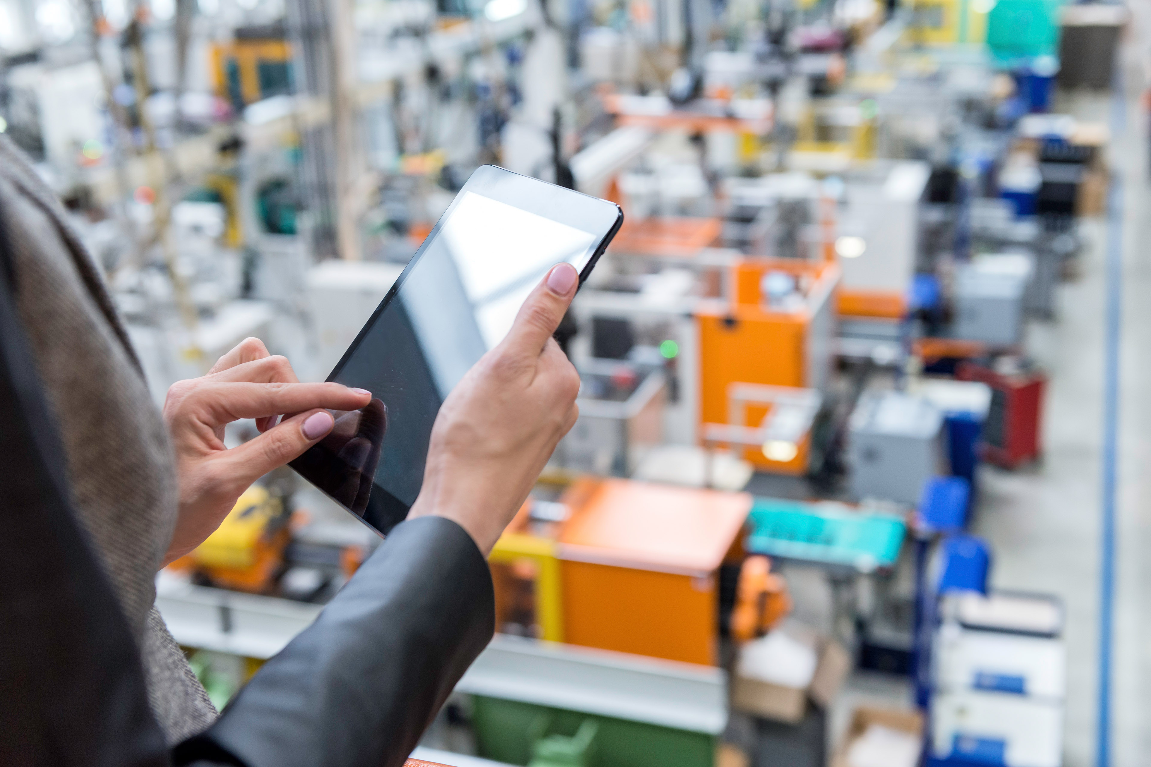 Female manager working on tablet in factory