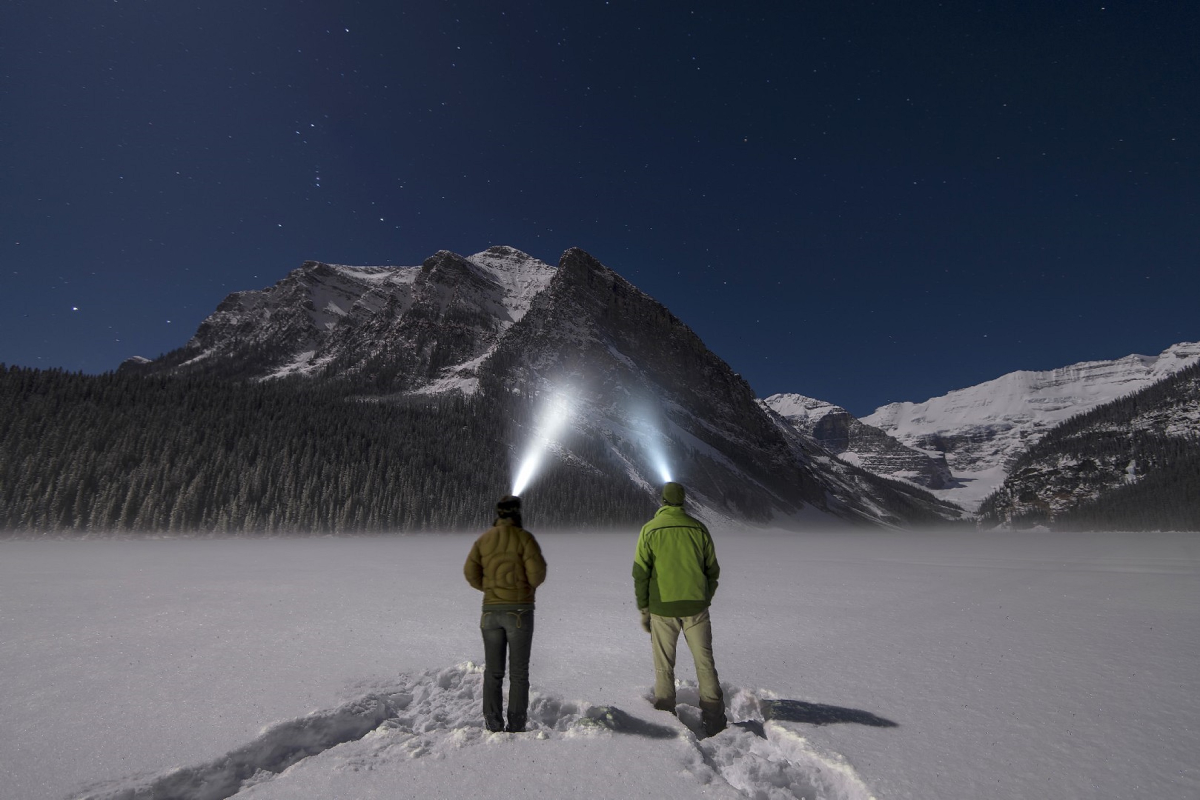 Two people watching mountain using light