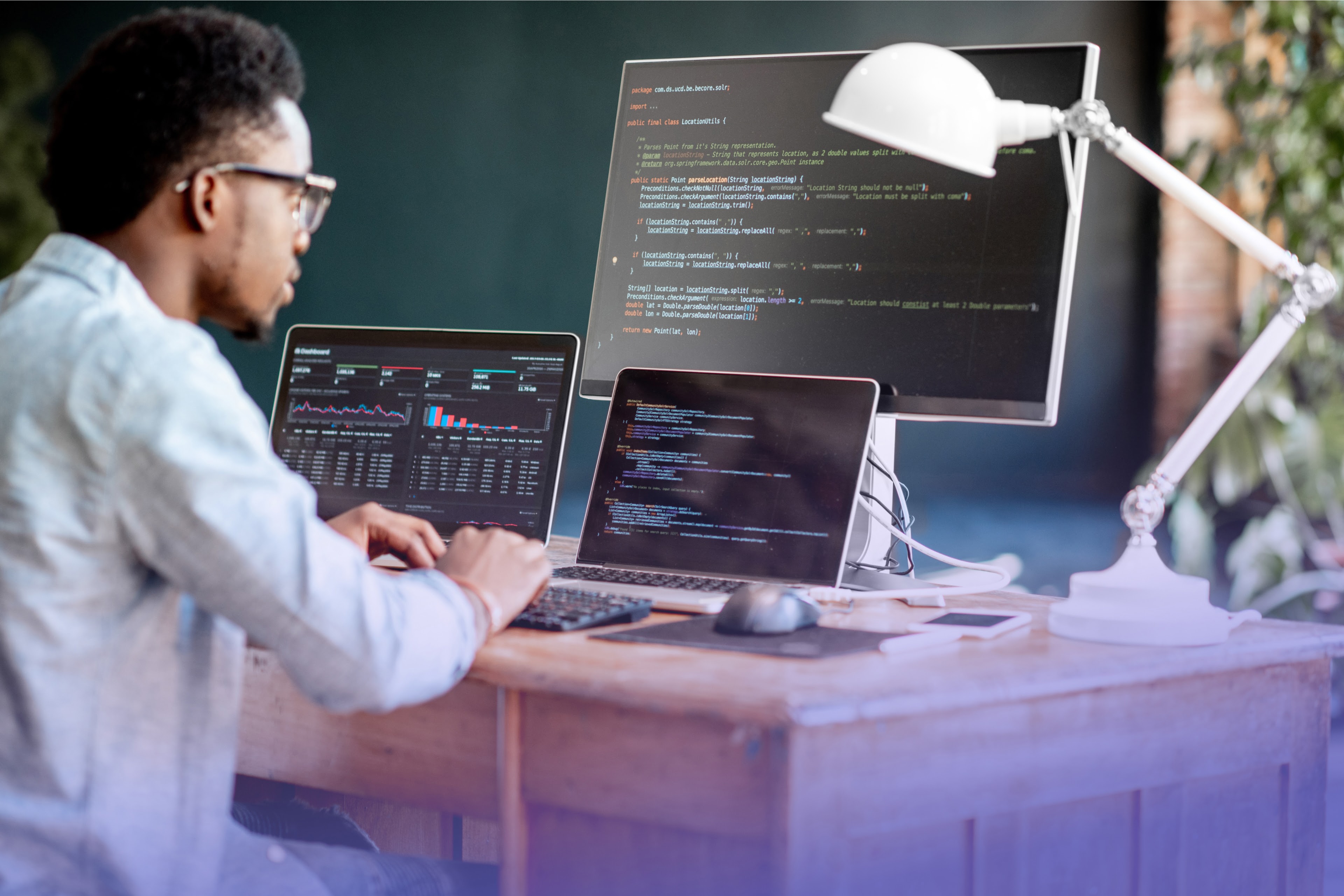 Man programming using multiple screens