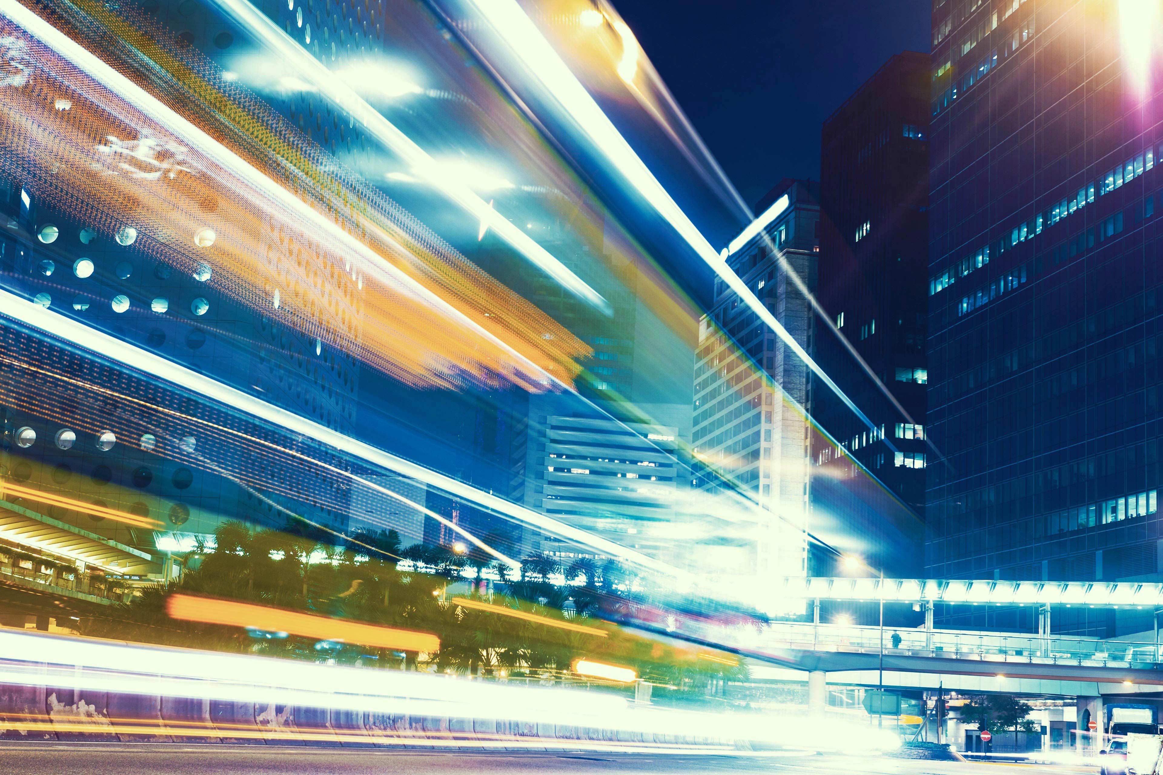 Traffic light trails in modern city at night