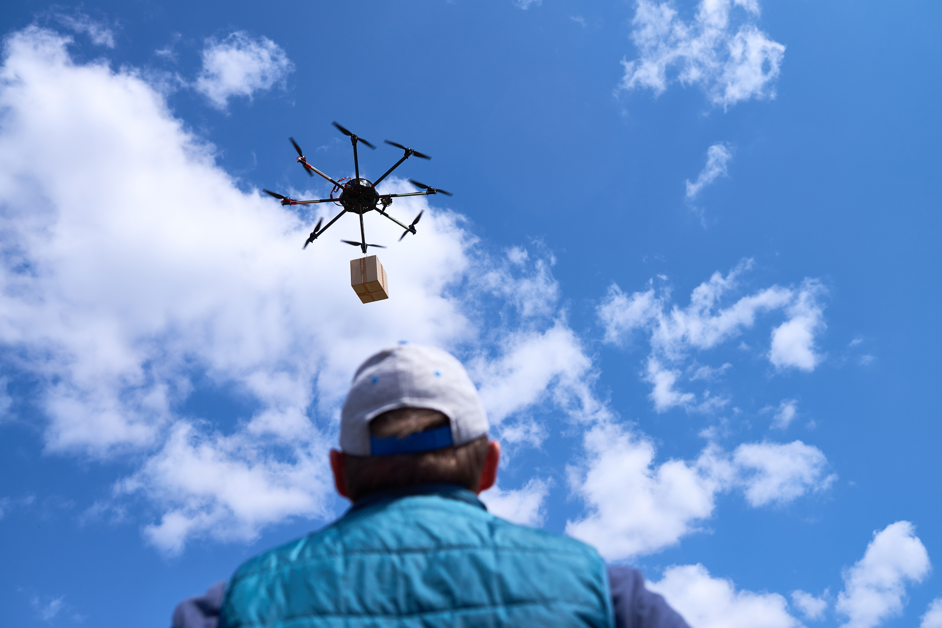 Man waiting for the drone delivering his package