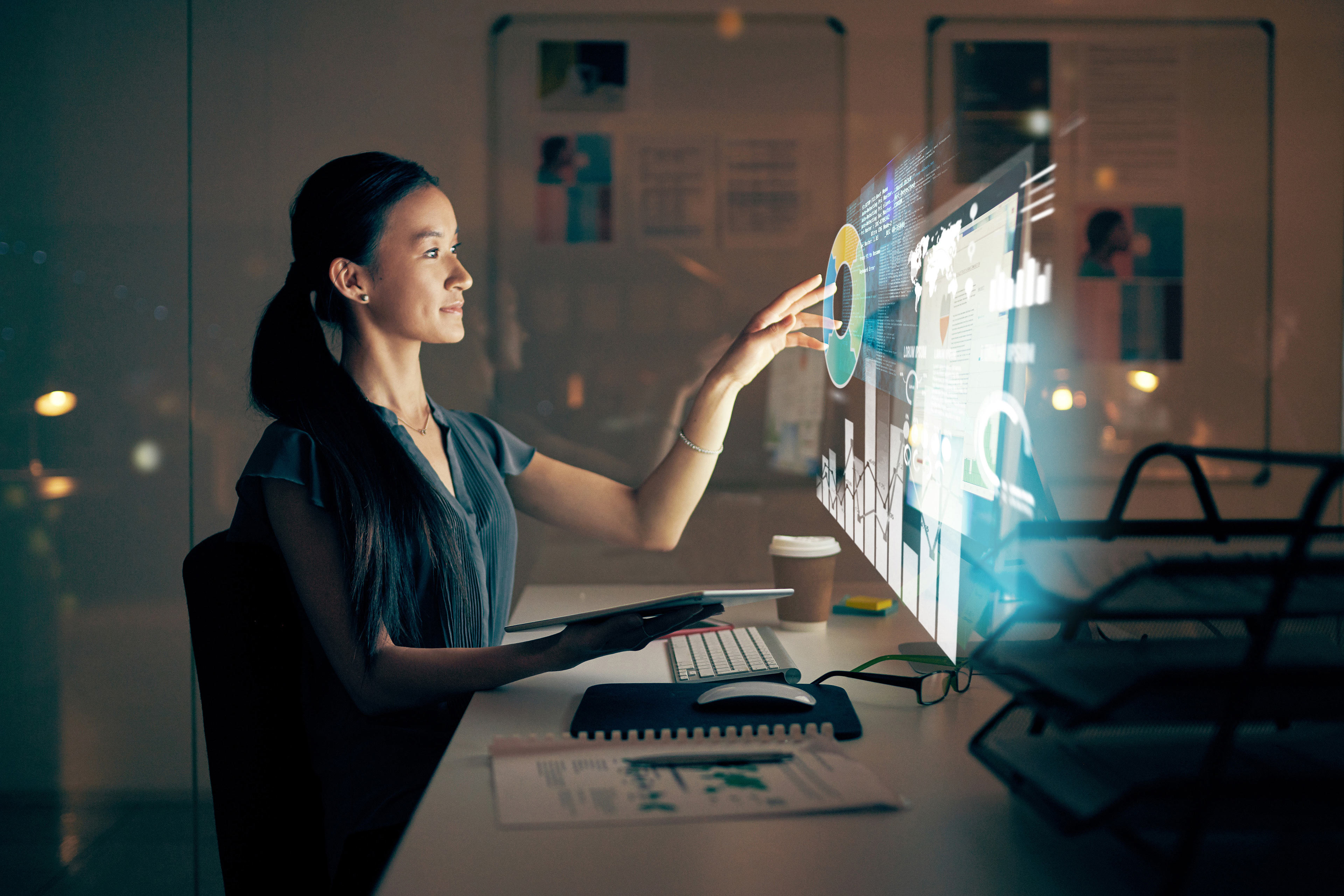 EY - Woman using a digital tablet and computer at night