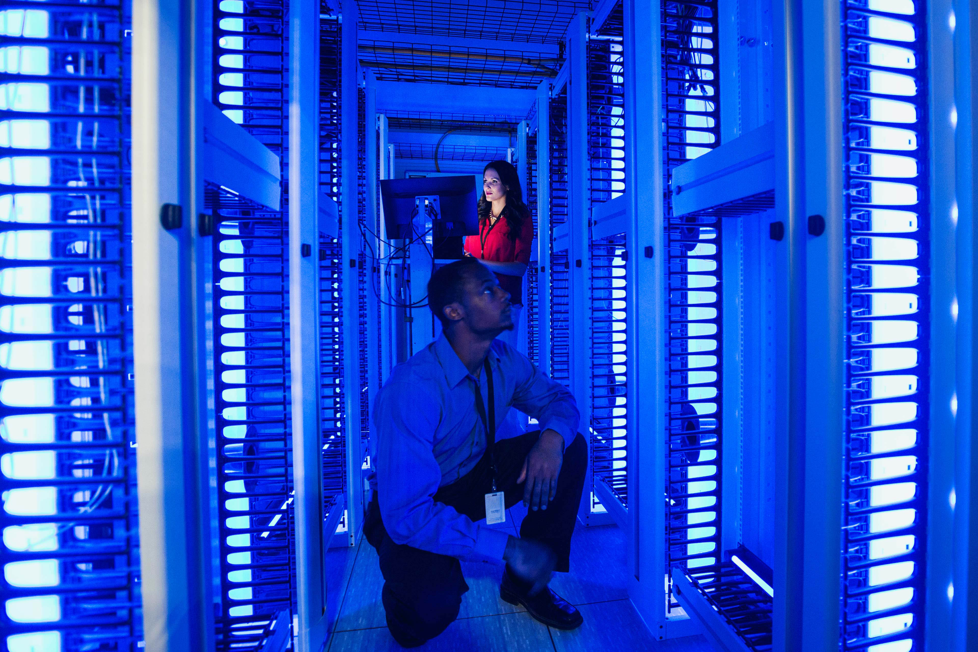 Business people working in server room