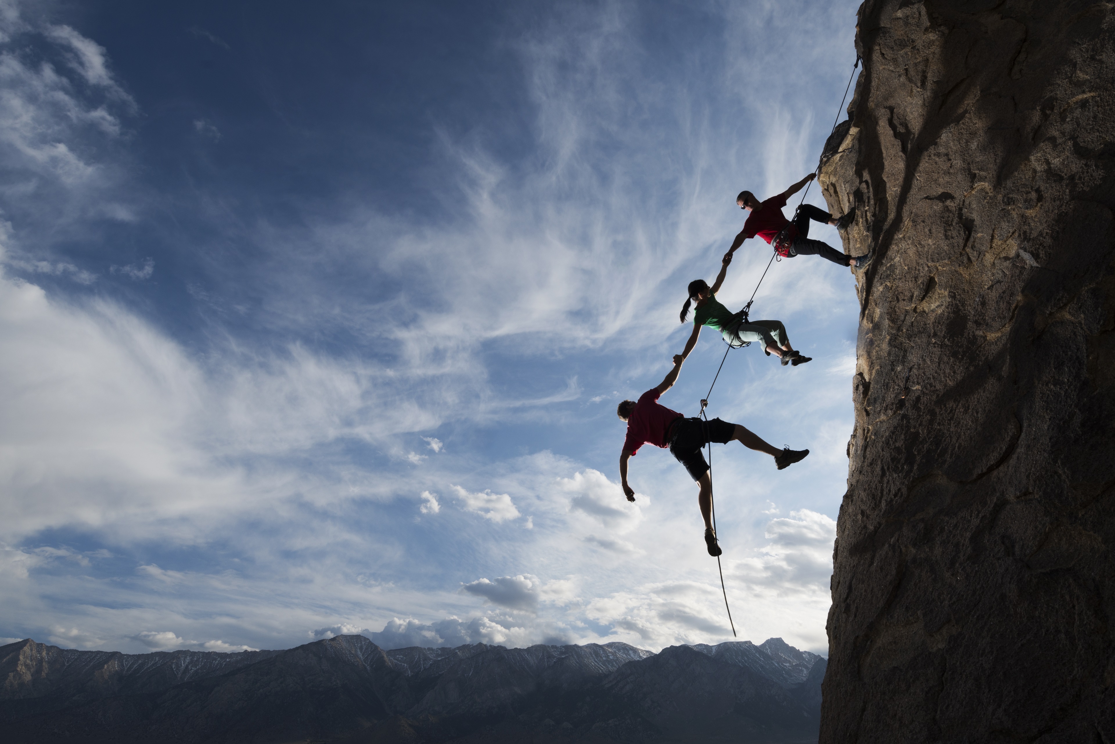 People climbing up a rock