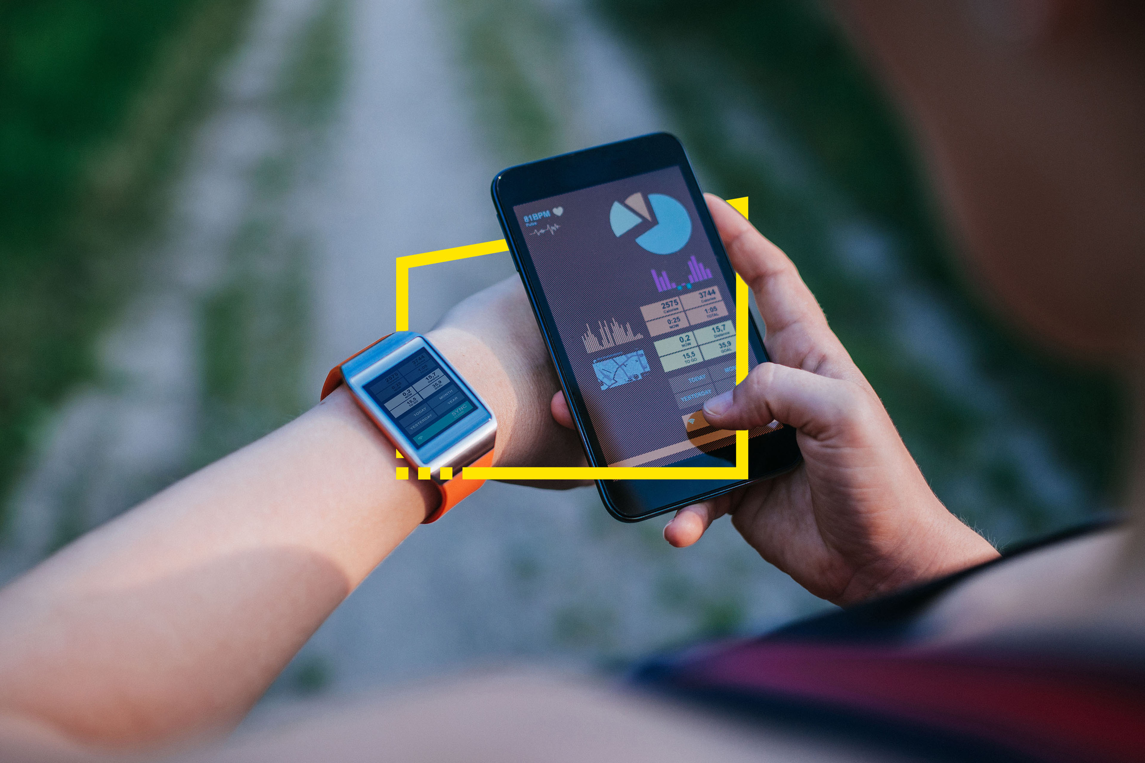 Woman synchronising smartwatch and mobile phone