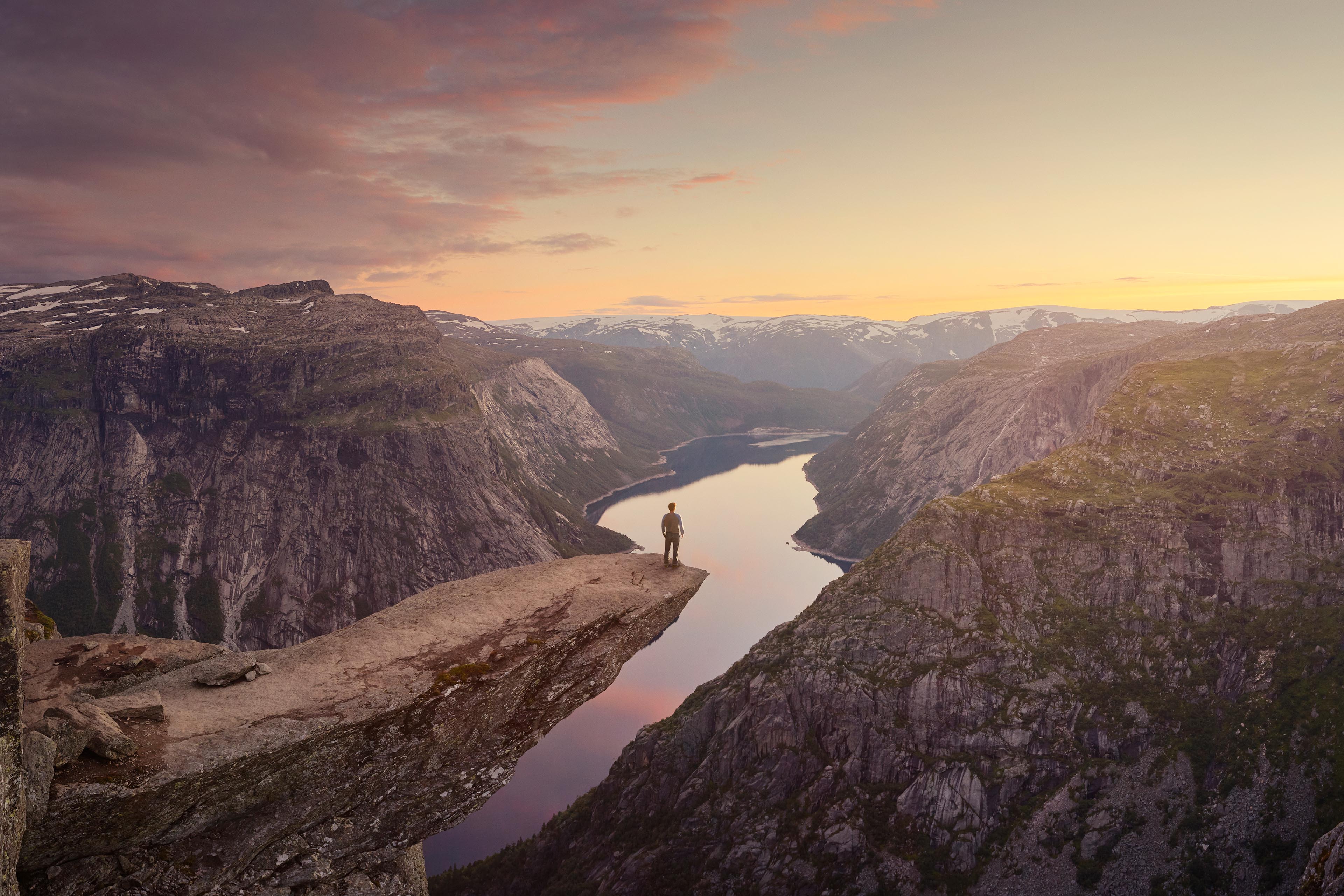 Traveller looking out at landscape at sunset