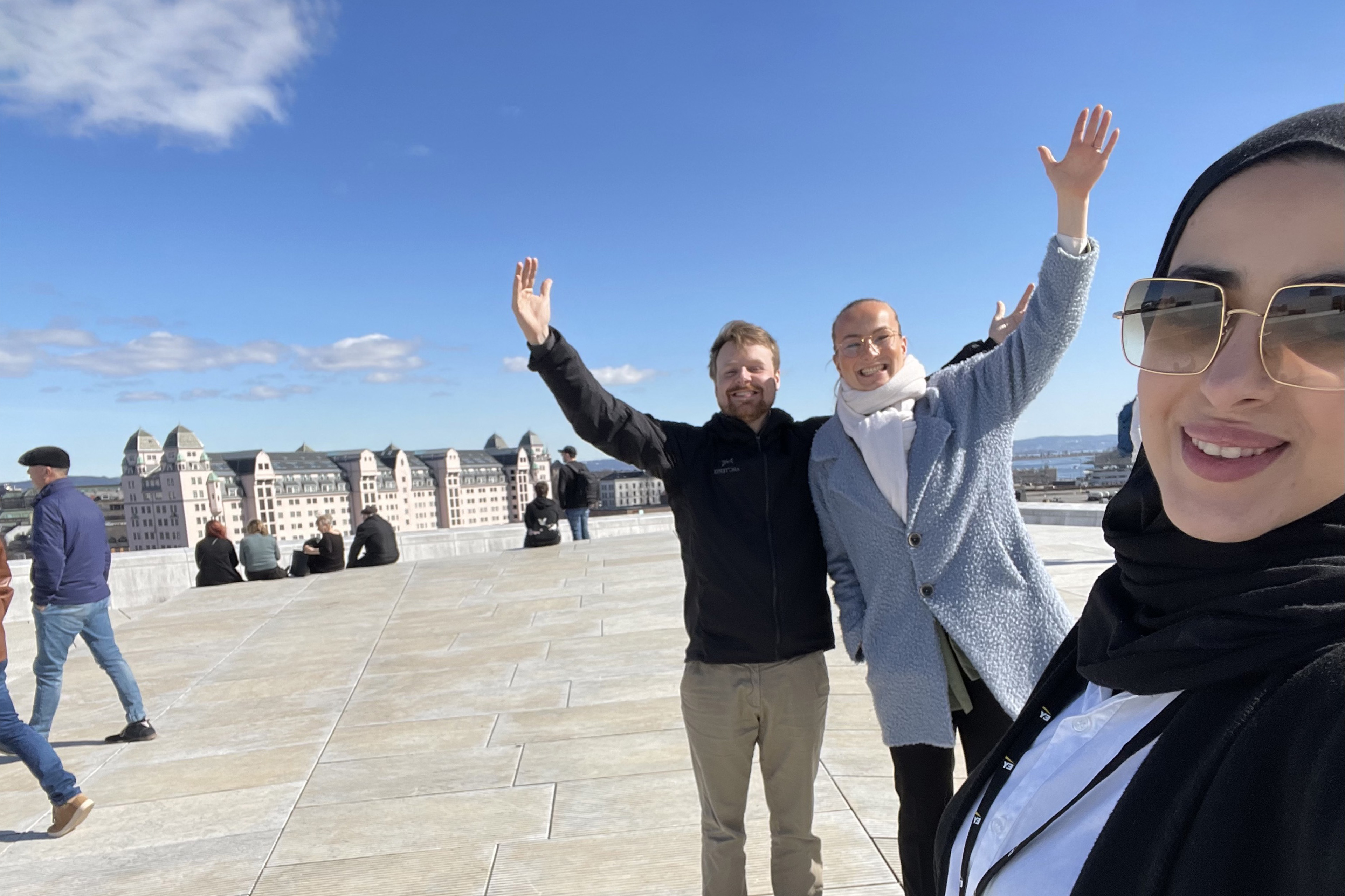 EY employees walking on the Oslo Opera House