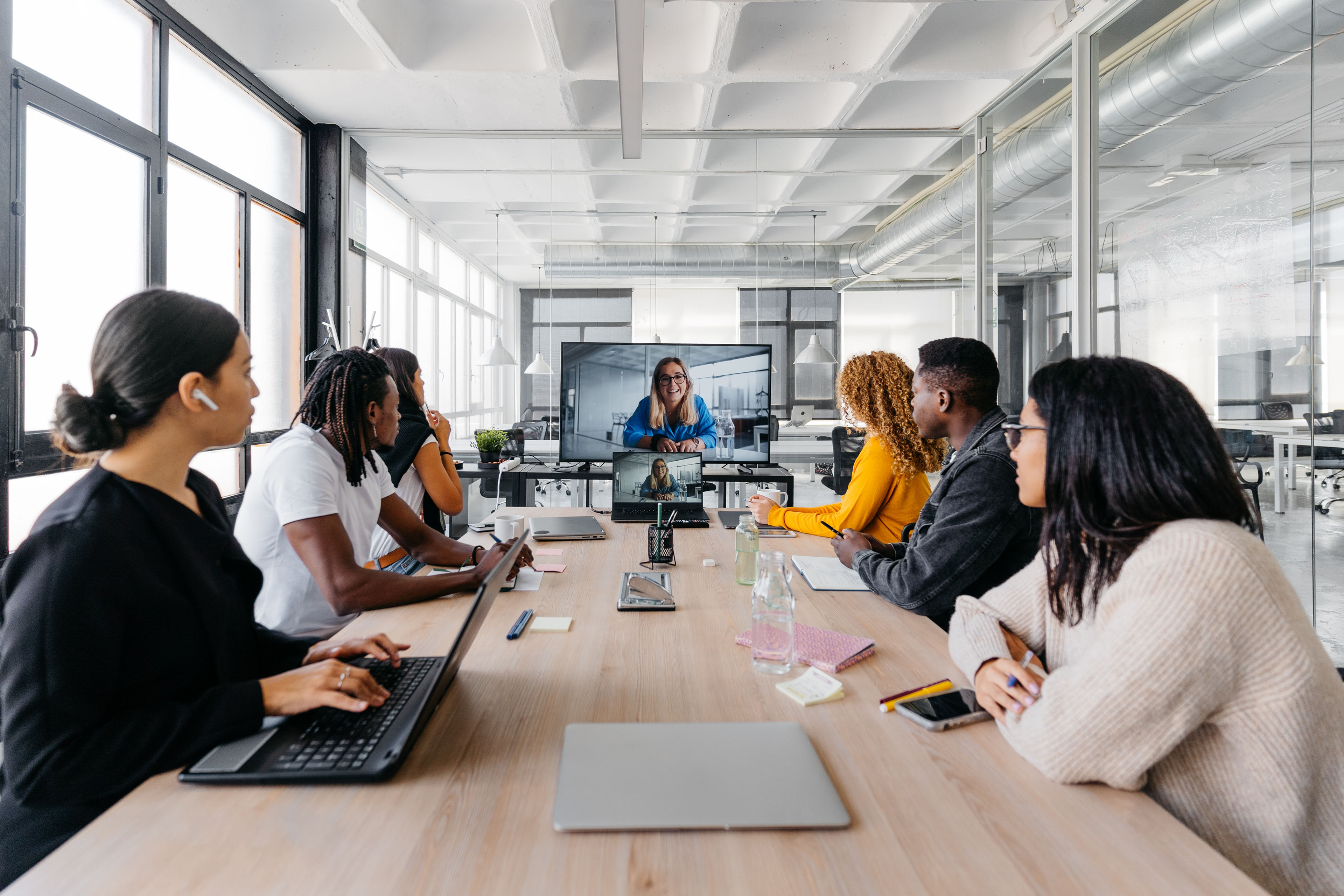 Group of multiracial businesspeople sitting around table having a remote video conference