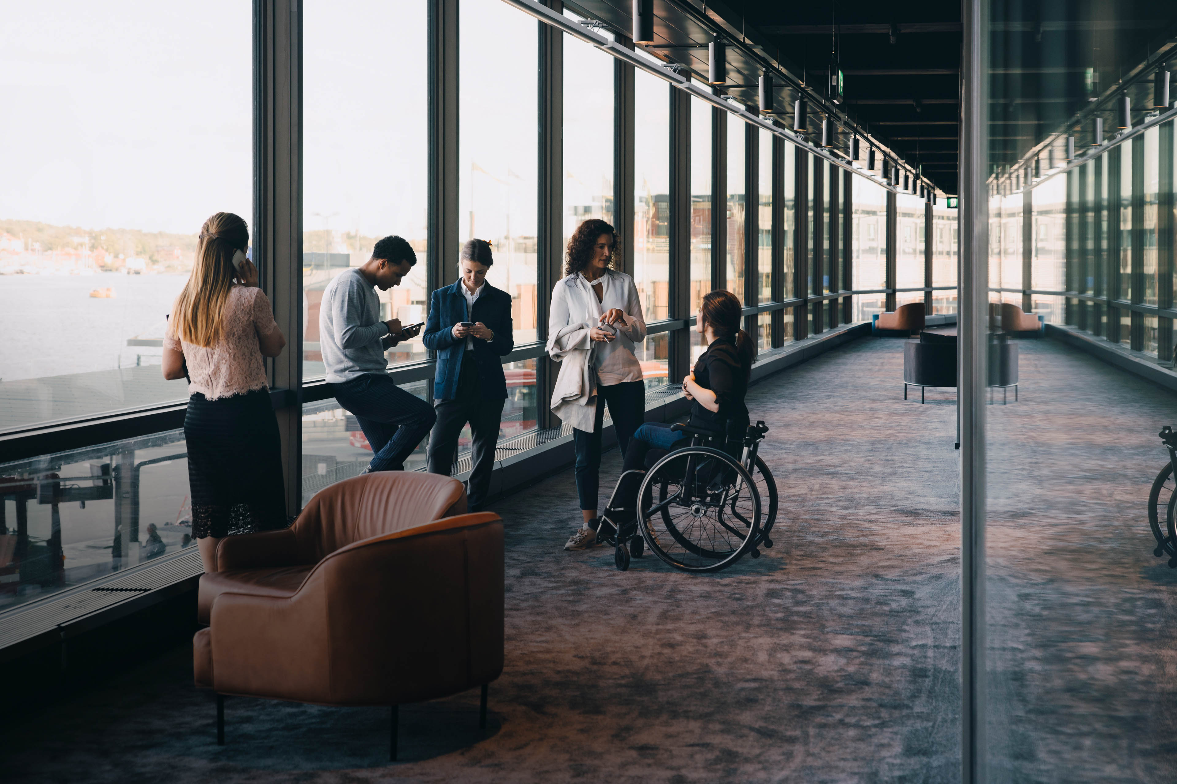 Male and female entrepreneurs standing in office corridor