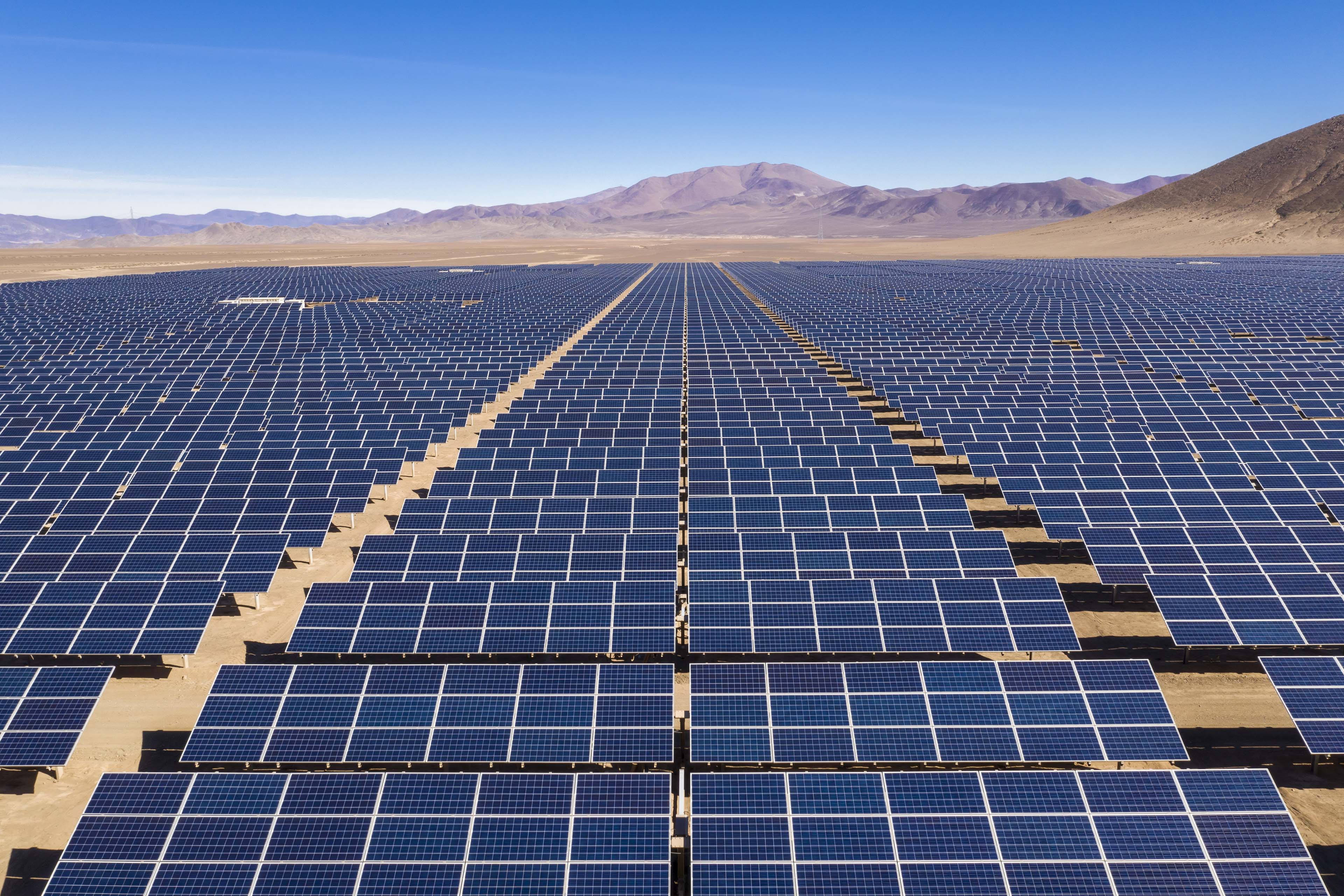 Aerial view of hundreds solar energy modules along the dry lands