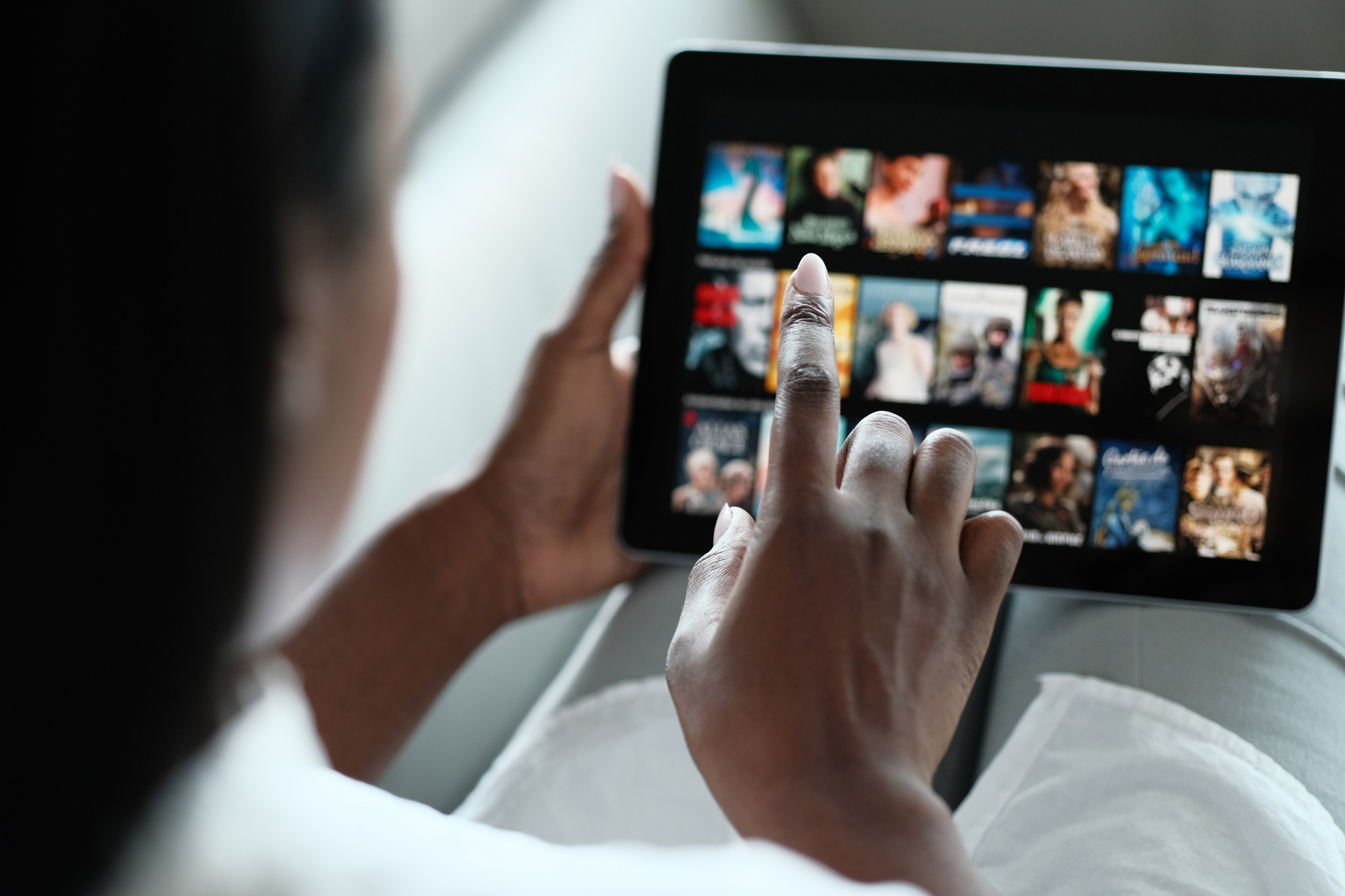 Black woman browsing movie on streaming media service