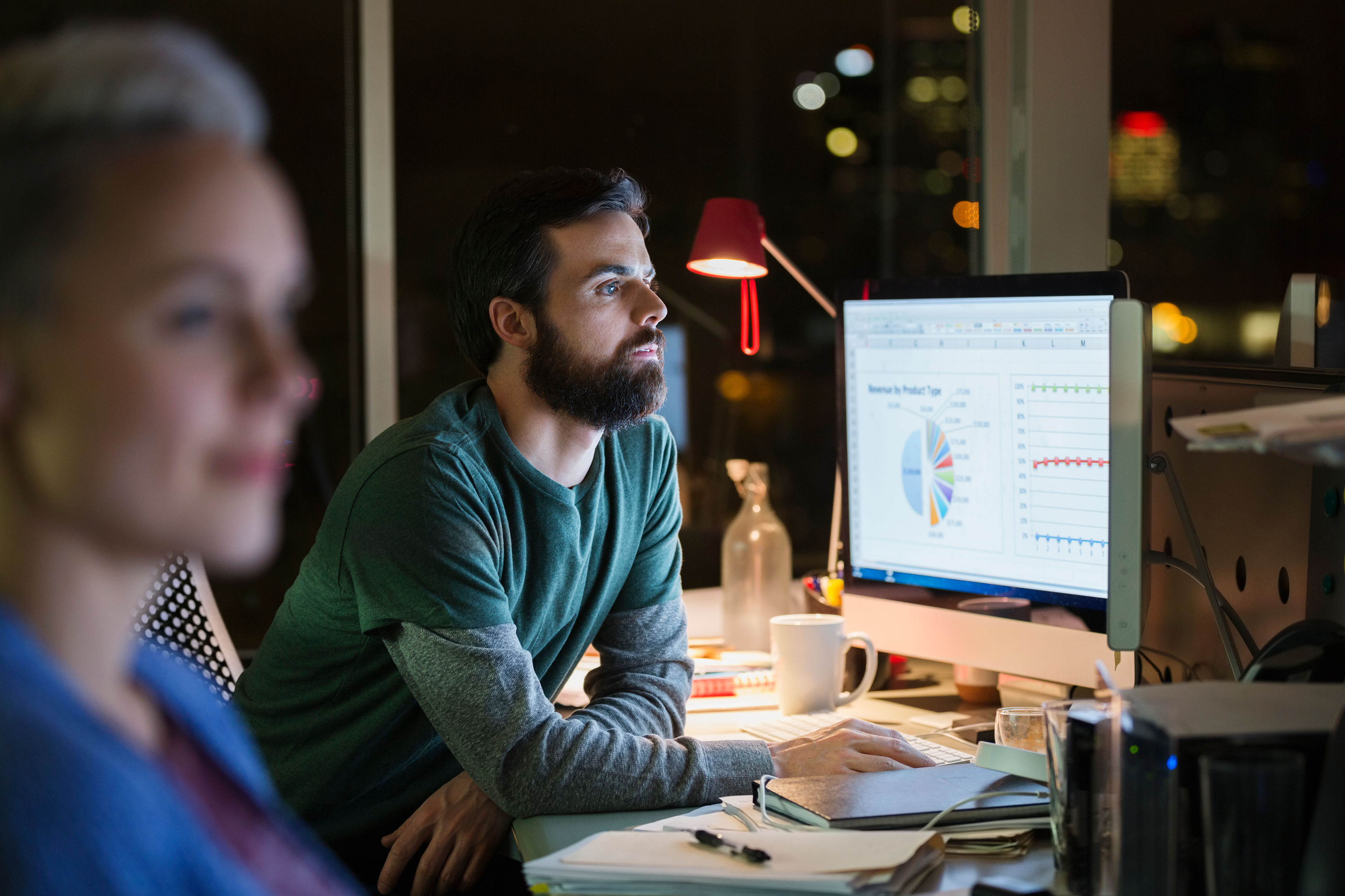 Business People Working Late At Computers In Office