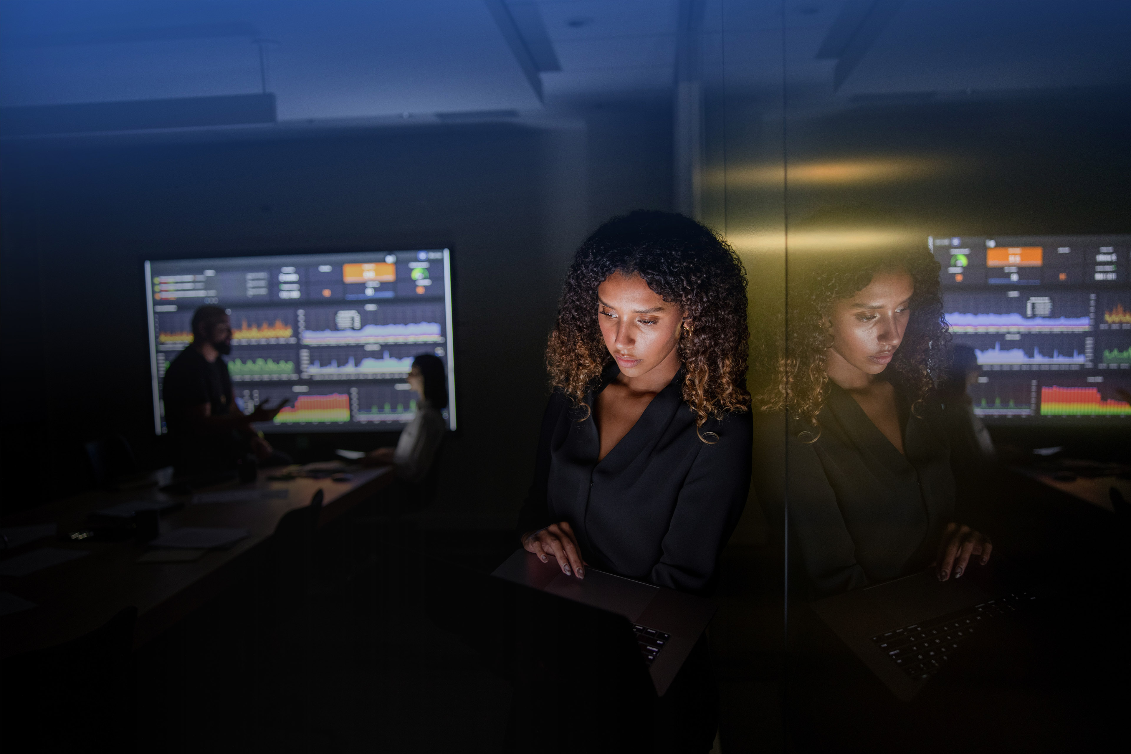 Businesswoman working late using digital tablet in conference room