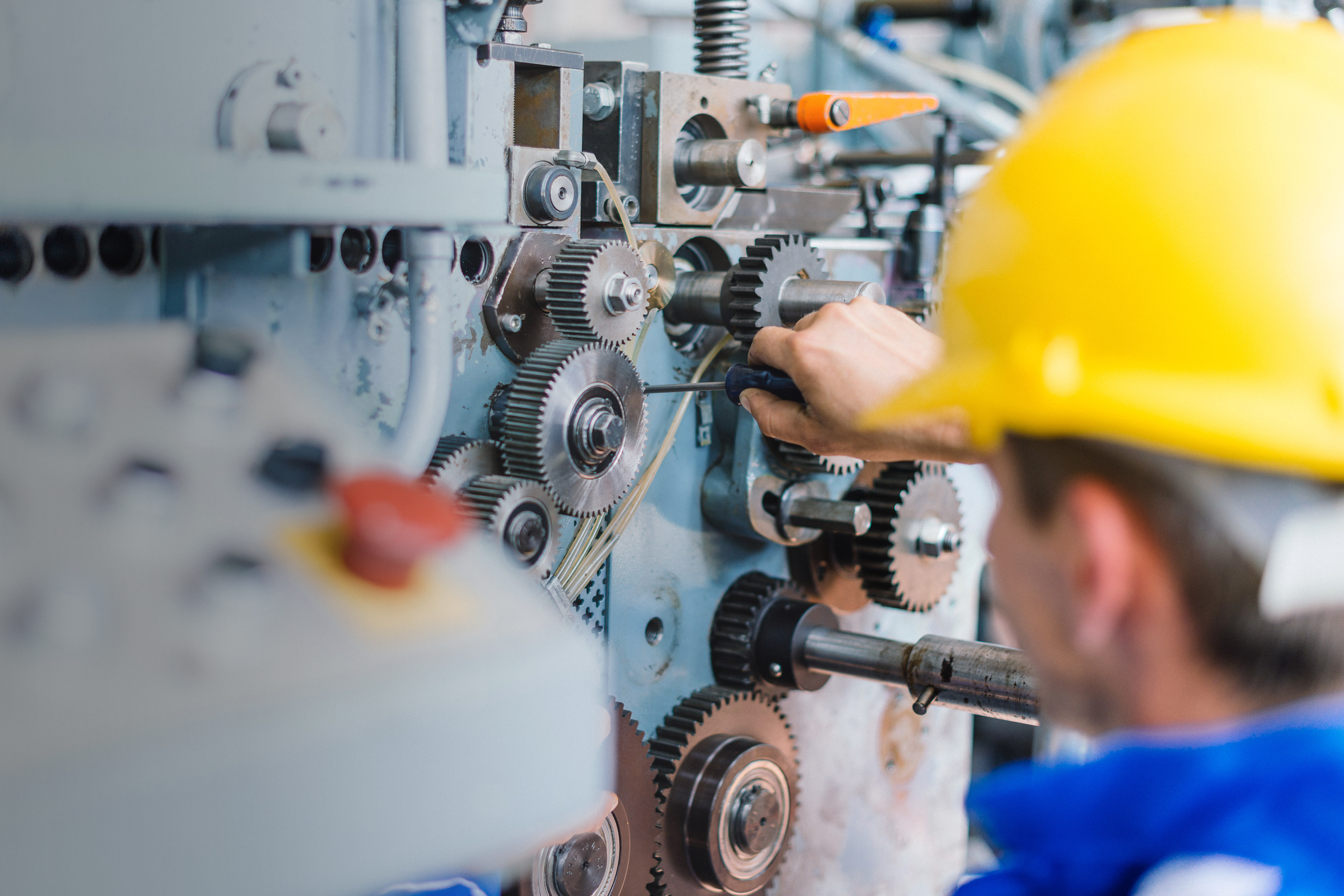 Engineer fixing cog wheels gears and machine teeth