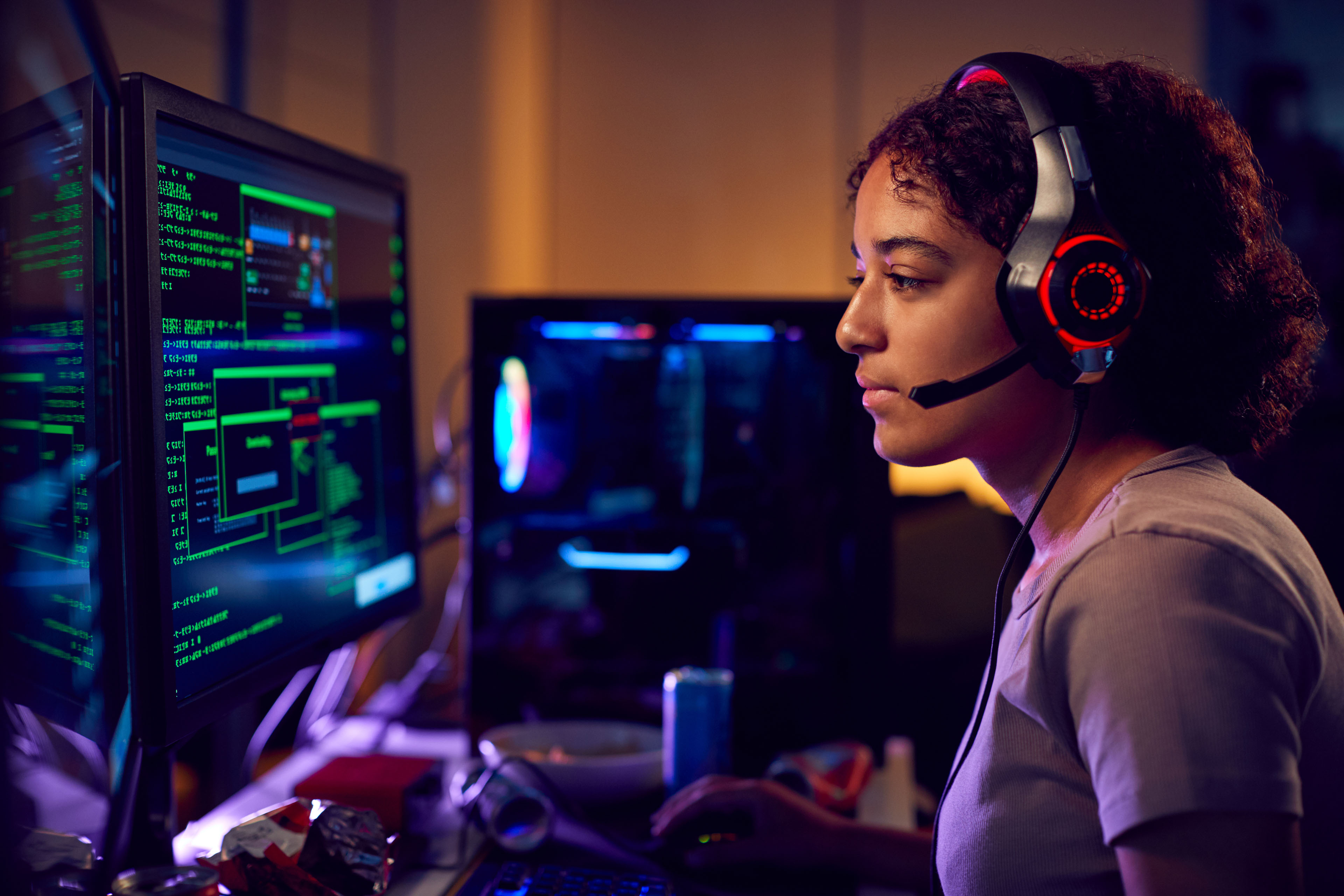 Female programmer In Front Of Computer Screens