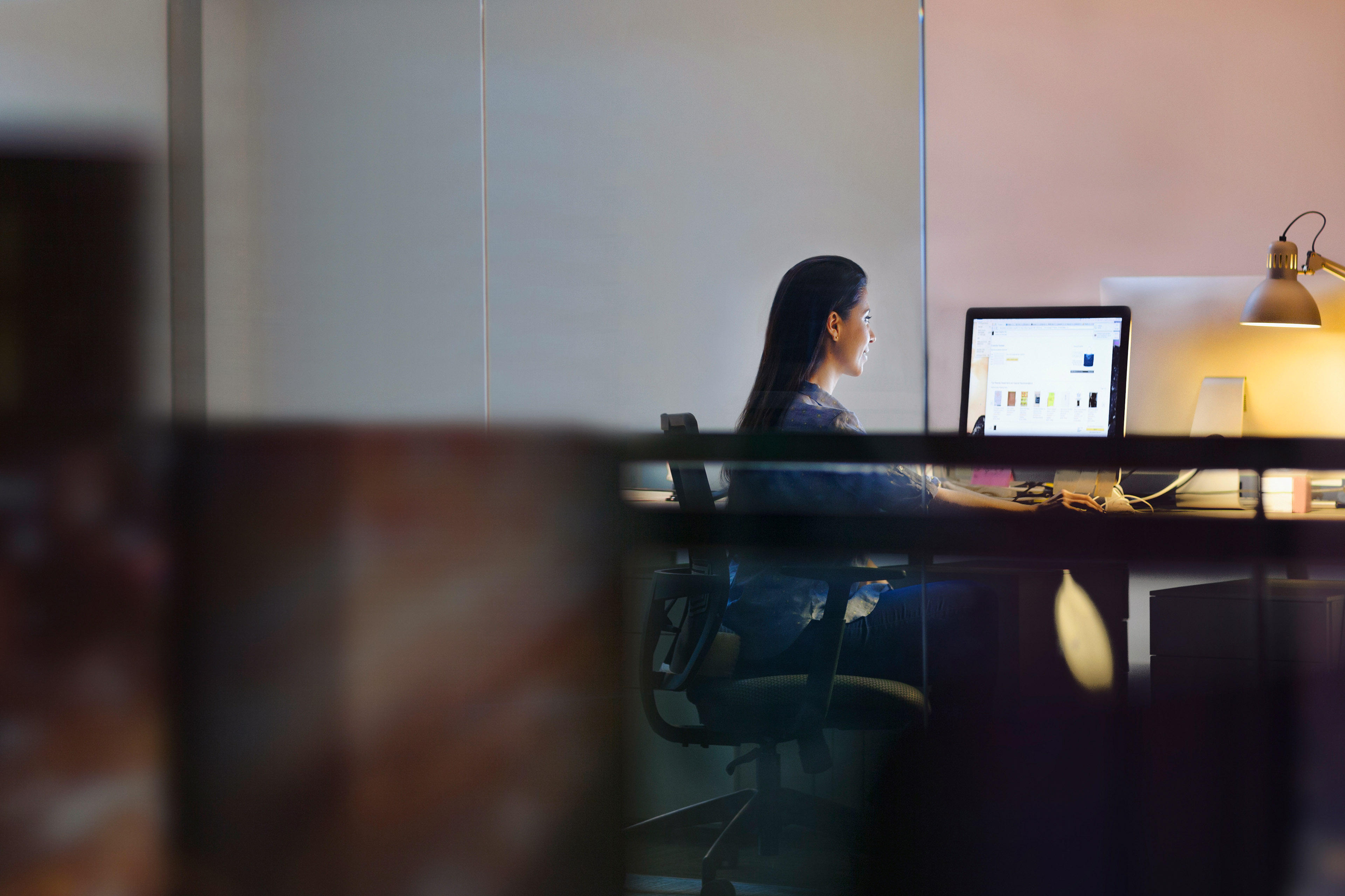 Woman working on computer in design studio