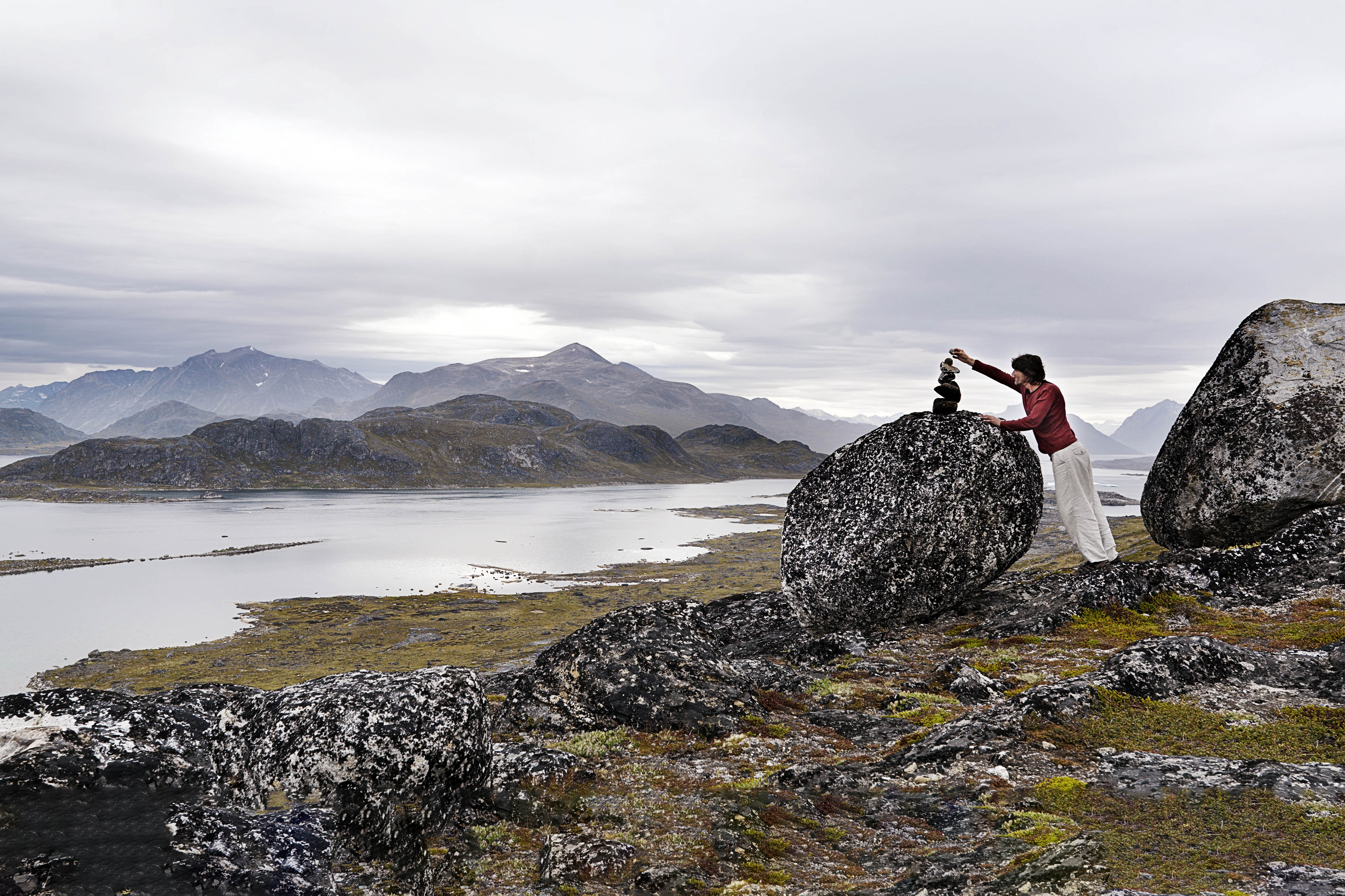 Man building rock cairns