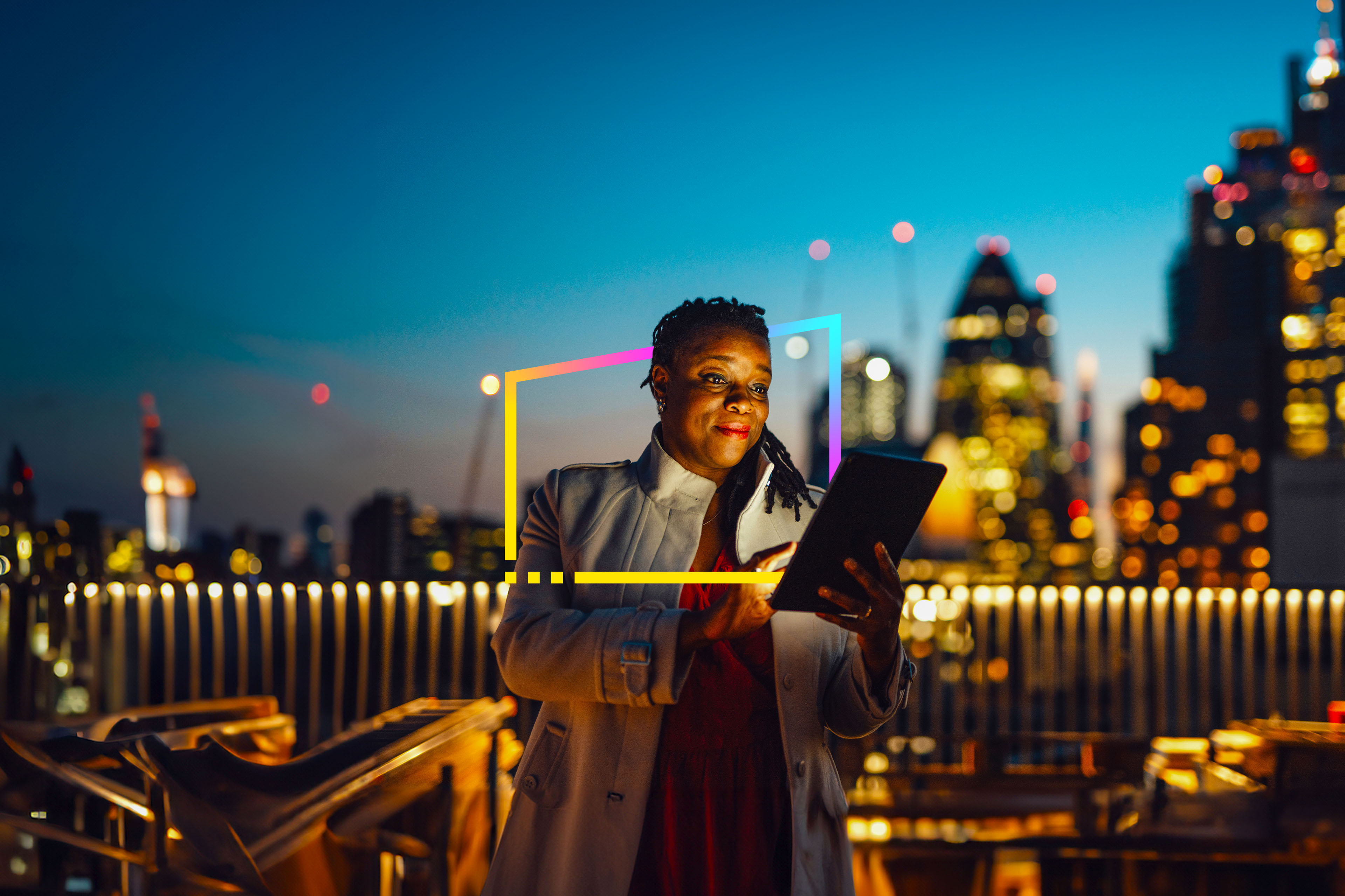 Businesswoman using digital tablet against London cityscape at night